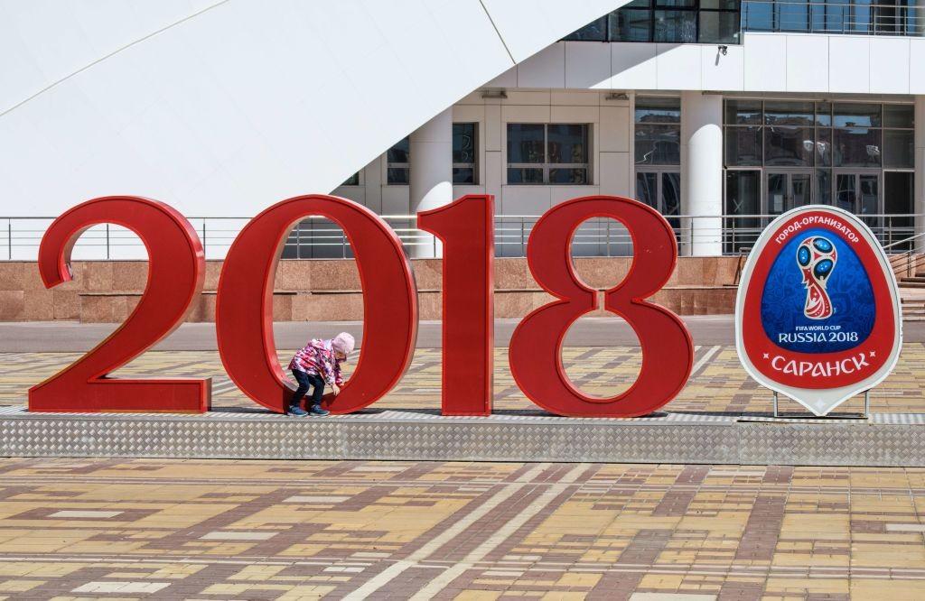 A child plays at the World Cup logo at Saransk's Millennium Square on May 4, 2018. - Saransk will host several games of the 2018 FIFA World Cup. (Photo by Mladen ANTONOV / AFP) (Photo credit should read MLADEN ANTONOV/AFP/Getty Images)