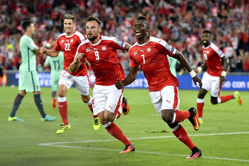 Switzerland's forward Breel Embolo (R) celebrates his team's first goal with teammate forward Haris Seferovic during the World Cup 2018 football qualifier between Switzerland and Portugal at the St. Jakob-Park stadium in Basel on September 6, 2016. / AFP / FABRICE COFFRINI (Photo credit should read FABRICE COFFRINI/AFP/Getty Images)