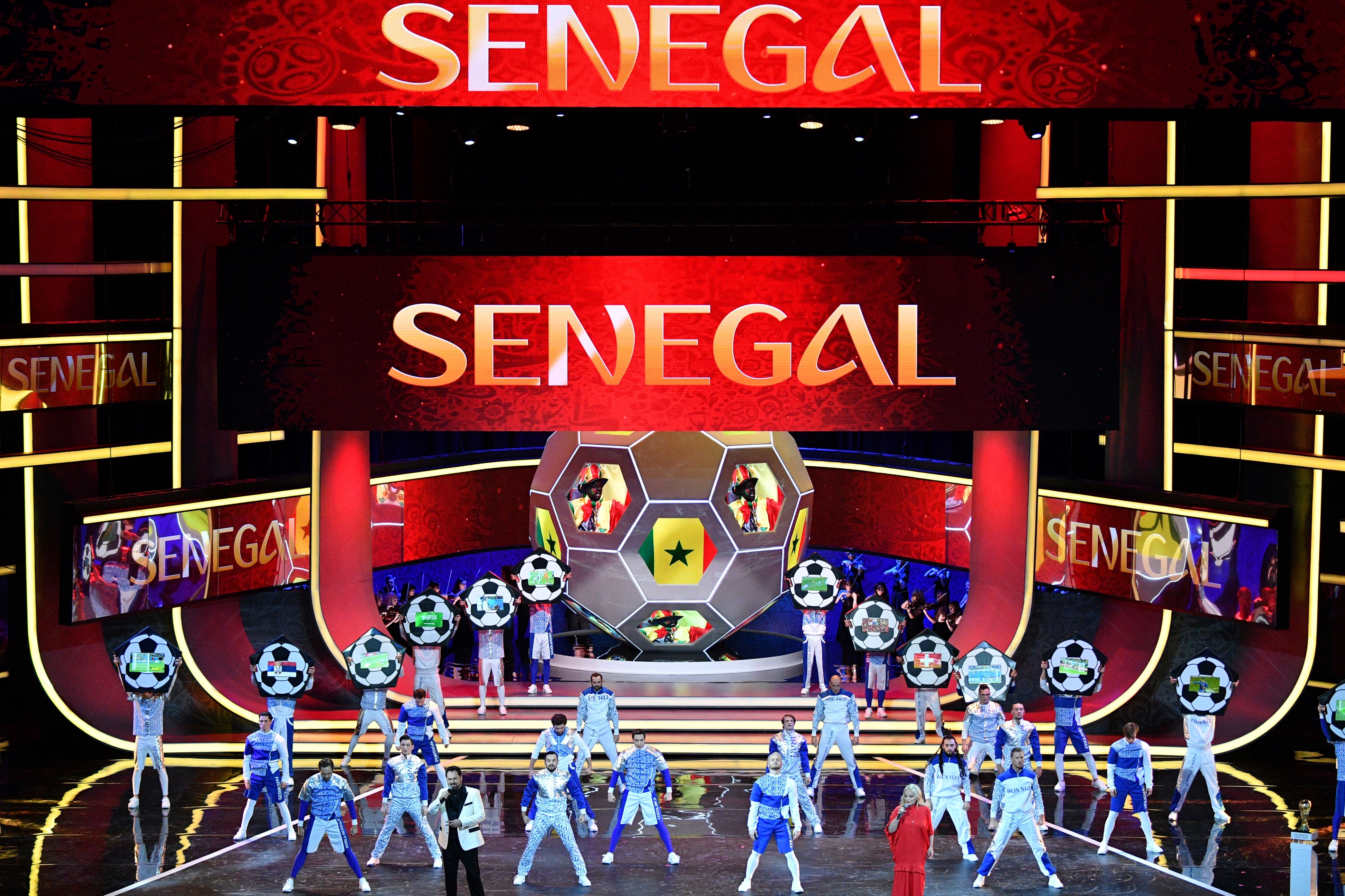 Artists perform on stage as "Senegal" is displayed on screens during the Final Draw for the 2018 FIFA World Cup football tournament at the State Kremlin Palace in Moscow on December 1, 2017.
The 2018 FIFA World Cup will be held from June 14 and July 15, 2018, in 11 Russian cities. / AFP PHOTO / Mladen ANTONOV        (Photo credit should read MLADEN ANTONOV/AFP/Getty Images)