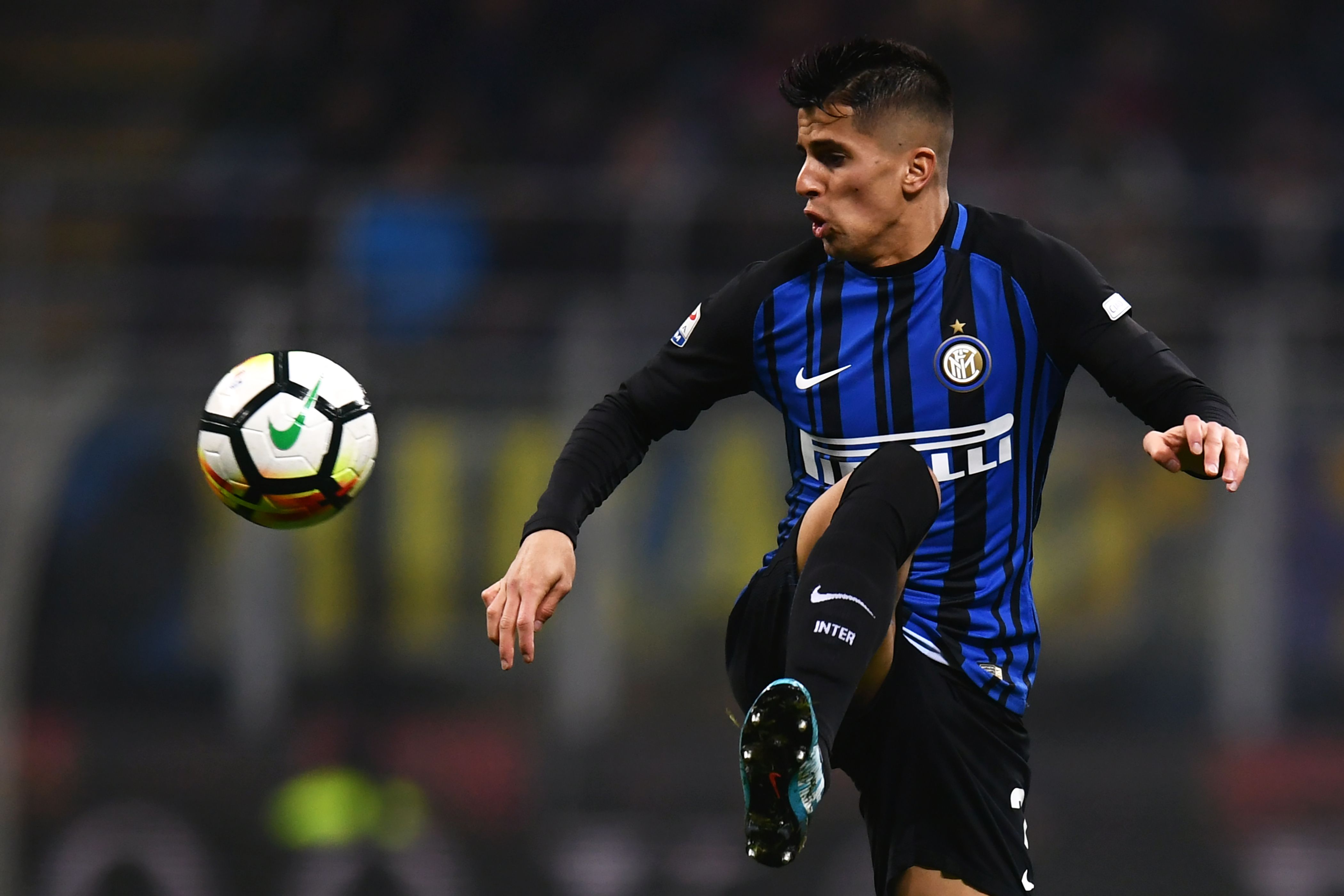 Inter Milan's Portuguese defender Joao Cancelo controls the ball during the Italian Serie A football match Inter Milan vs Napoli on March 11, 2018 at the San Siro stadium in Milan. / AFP PHOTO / MARCO BERTORELLO        (Photo credit should read MARCO BERTORELLO/AFP/Getty Images)