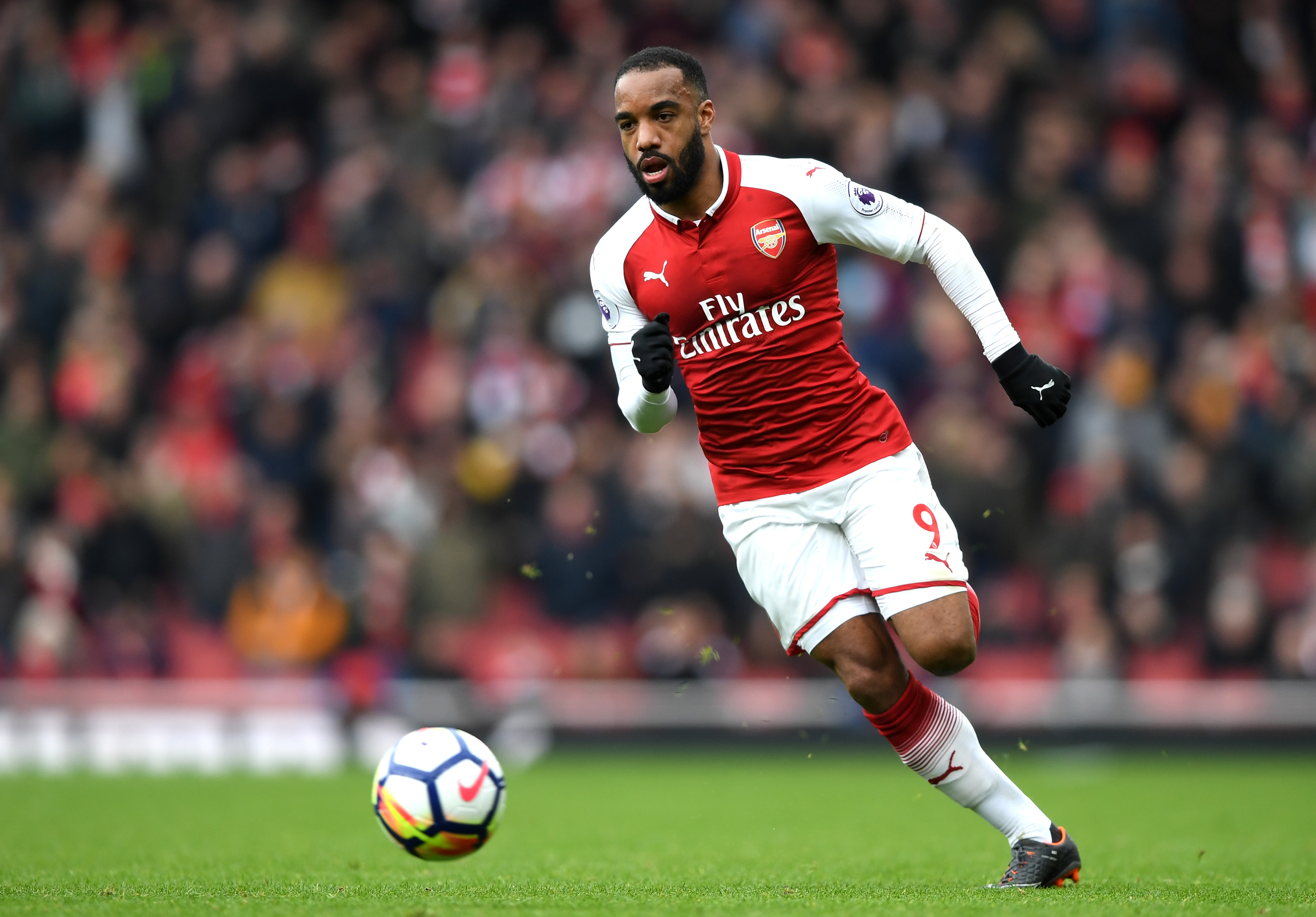 LONDON, ENGLAND - APRIL 01: Alexandre Lacazette of Arsenal runs with the ball during the Premier League match between Arsenal and Stoke City at Emirates Stadium on April 1, 2018 in London, England.  (Photo by Shaun Botterill/Getty Images)