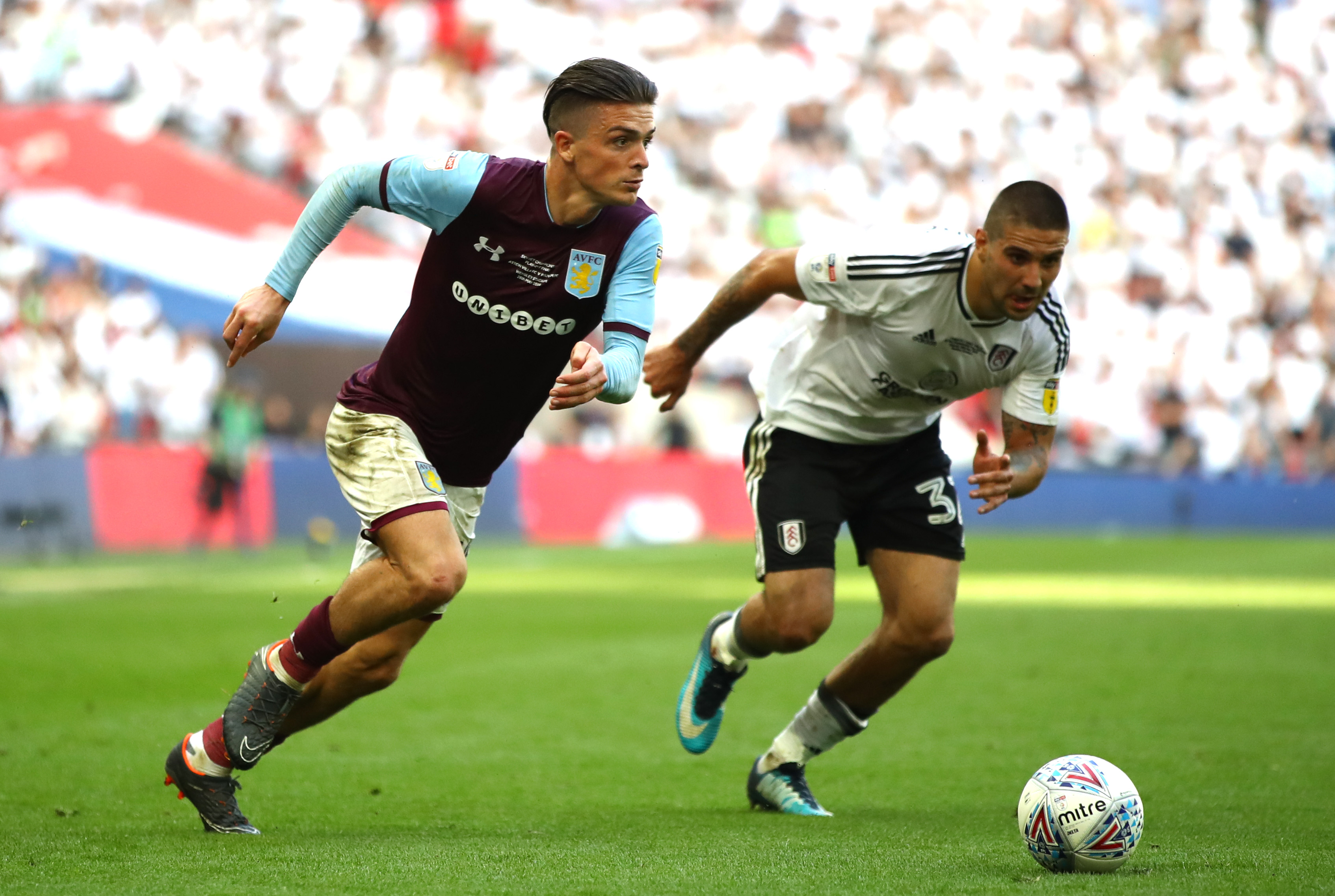 LONDON, ENGLAND - MAY 26:  Jack Grealish of Aston Villa runs with the ball under pressure from Aleksandar Mitrovic of Fulham during the Sky Bet Championship Play Off Final between Aston Villa and  Fulham at Wembley Stadium on May 26, 2018 in London, England.  (Photo by Clive Mason/Getty Images)