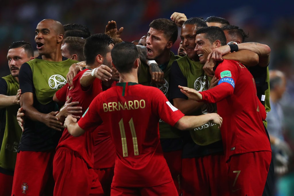 SOCHI, RUSSIA - JUNE 15: Cristiano Ronaldo of Portugal celebrates with team mates after scoring his team's second goal of the match during the 2018 FIFA World Cup Russia group B match between Portugal and Spain at Fisht Stadium on June 15, 2018 in Sochi, Russia. (Photo by Dean Mouhtaropoulos/Getty Images)