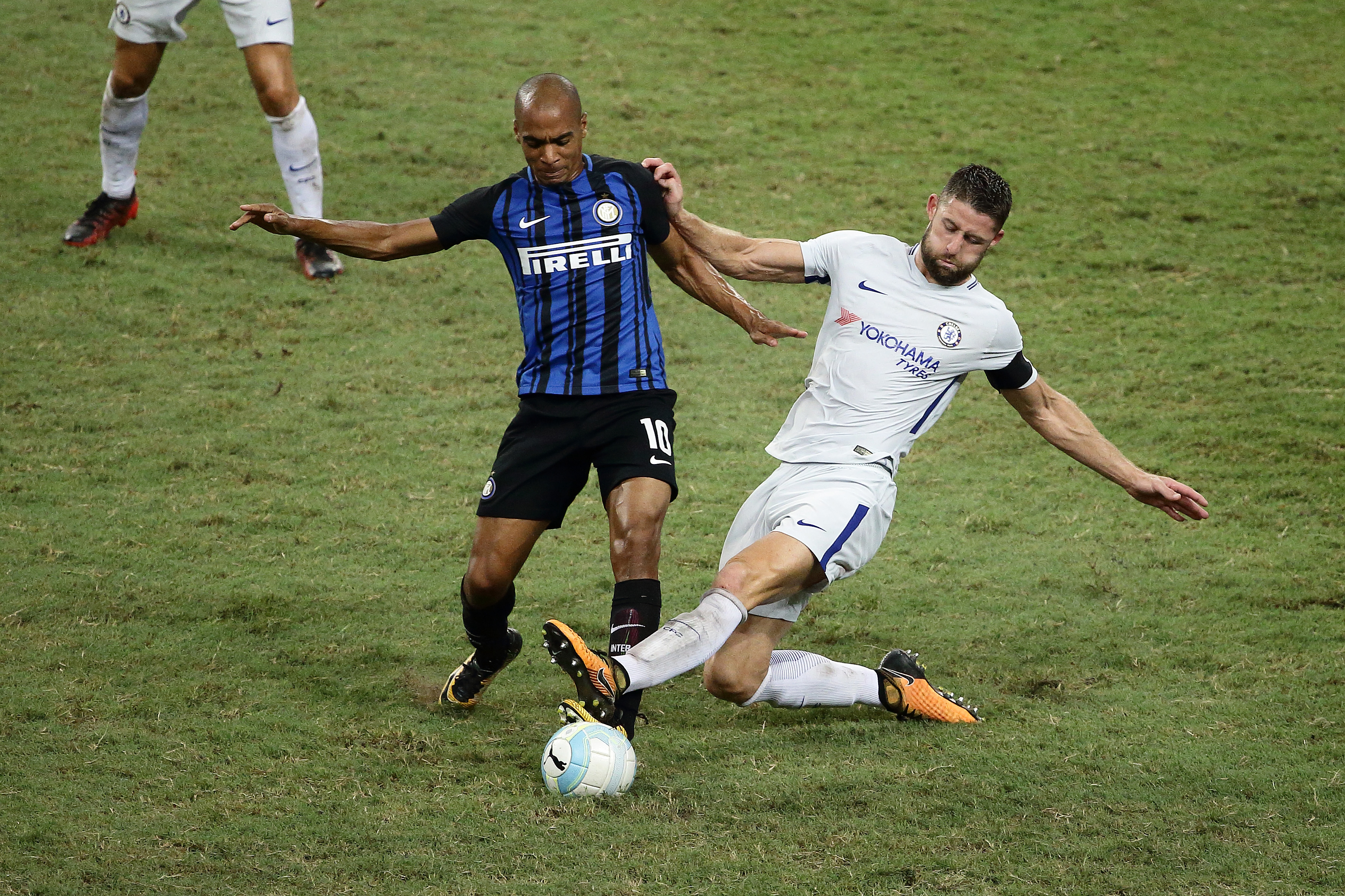 SINGAPORE - JULY 29: Gary Cahill (R) of Chelsea FC and Joao Mario of FC Internazionale challenge for the ball during the International Champions Cup match between FC Internazionale and Chelsea FC at National Stadium on July 29, 2017 in Singapore. (Photo by Suhaimi Abdullah/Getty Images for ICC)