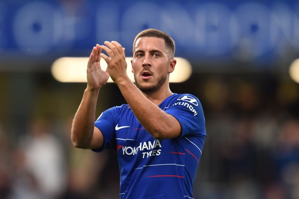 Chelsea's Belgian midfielder Eden Hazard applauds supporters on the pitch after the English Premier League football match between Chelsea and Arsenal at Stamford Bridge in London on August 18, 2018. - Chelsea won the game 3-2. (Photo by Glyn KIRK / AFP) / RESTRICTED TO EDITORIAL USE. No use with unauthorized audio, video, data, fixture lists, club/league logos or 'live' services. Online in-match use limited to 120 images. An additional 40 images may be used in extra time. No video emulation. Social media in-match use limited to 120 images. An additional 40 images may be used in extra time. No use in betting publications, games or single club/league/player publications. / (Photo credit should read GLYN KIRK/AFP/Getty Images)