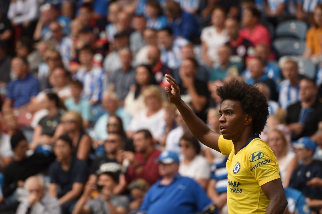 Chelsea's Brazilian midfielder Willian gestures during the English Premier League football match between Huddersfield Town and Chelsea at the John Smith's stadium in Huddersfield, northern England on August 11, 2018. (Photo by Oli SCARFF / AFP) / RESTRICTED TO EDITORIAL USE.No use with unauthorized audio, video, data, fixture lists, club/league logos or 'live' services. Online in-match use limited to 120 images. An additional 40 images may be used in extra time. No video emulation. Social media in-match use limited to 120 images. An additional 40 images may be used in extra time. No use in betting publications, games or single club/league/player publications/ / (Photo credit should read OLI SCARFF/AFP/Getty Images)