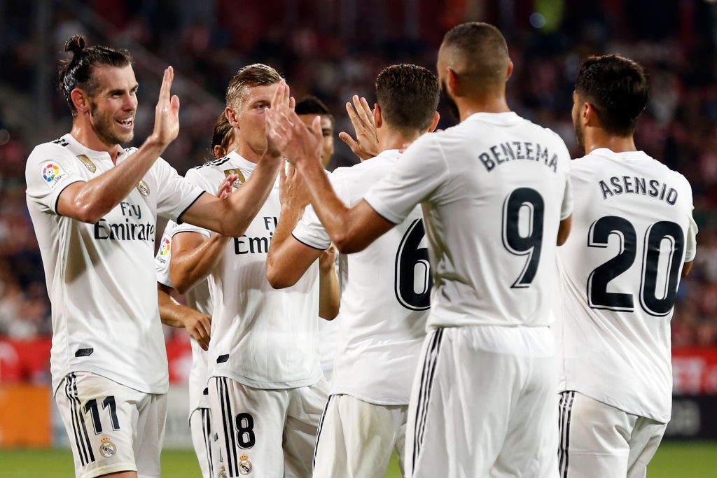 Real Madrid players celebrate their fourth goal scored by Real Madrid's French forward Karim Benzema during the Spanish league football match between Girona FC and Real Madrid CF at the Montilivi stadium in Girona on August 26, 2018. (Photo by Pau BARRENA CAPILLA / AFP) (Photo credit should read PAU BARRENA CAPILLA/AFP/Getty Images)