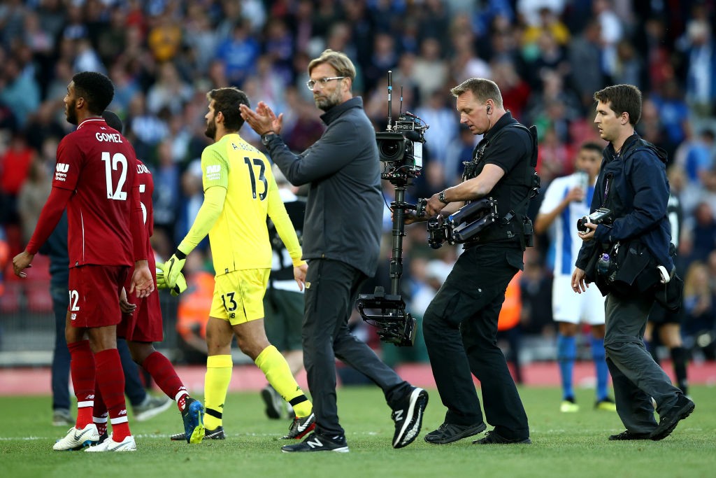 LIVERPOOL, ENGLAND - AUGUST 25: A camera operator films Jurgen Klopp applauding the fans during the Premier League match between Liverpool FC and Brighton & Hove Albion at Anfield on August 25, 2018 in Liverpool, United Kingdom. (Photo by Jan Kruger/Getty Images)