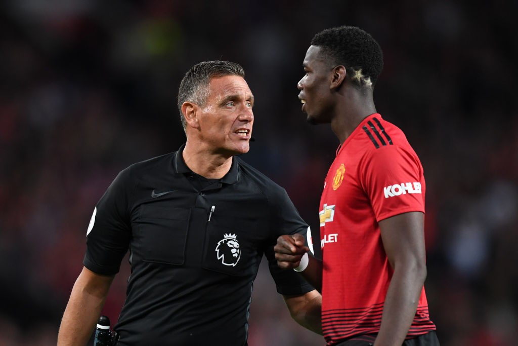 MANCHESTER, ENGLAND - AUGUST 10: Referee Andre Marriner speaks to Paul Pogba of Manchester United during the Premier League match between Manchester United and Leicester City at Old Trafford on August 10, 2018 in Manchester, United Kingdom. (Photo by Michael Regan/Getty Images)
