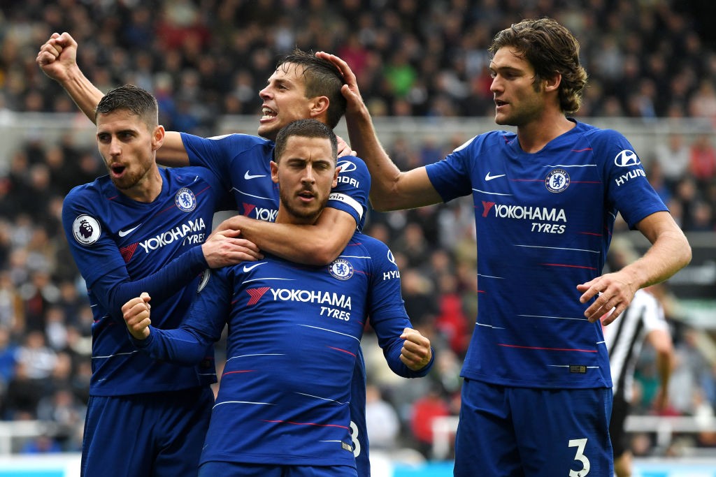 NEWCASTLE UPON TYNE, ENGLAND - AUGUST 26: Eden Hazard of Chelsea celebrates with teammates after scoring a penalty for his team's first goal during the Premier League match between Newcastle United and Chelsea FC at St. James Park on August 26, 2018 in Newcastle upon Tyne, United Kingdom. (Photo by Stu Forster/Getty Images)