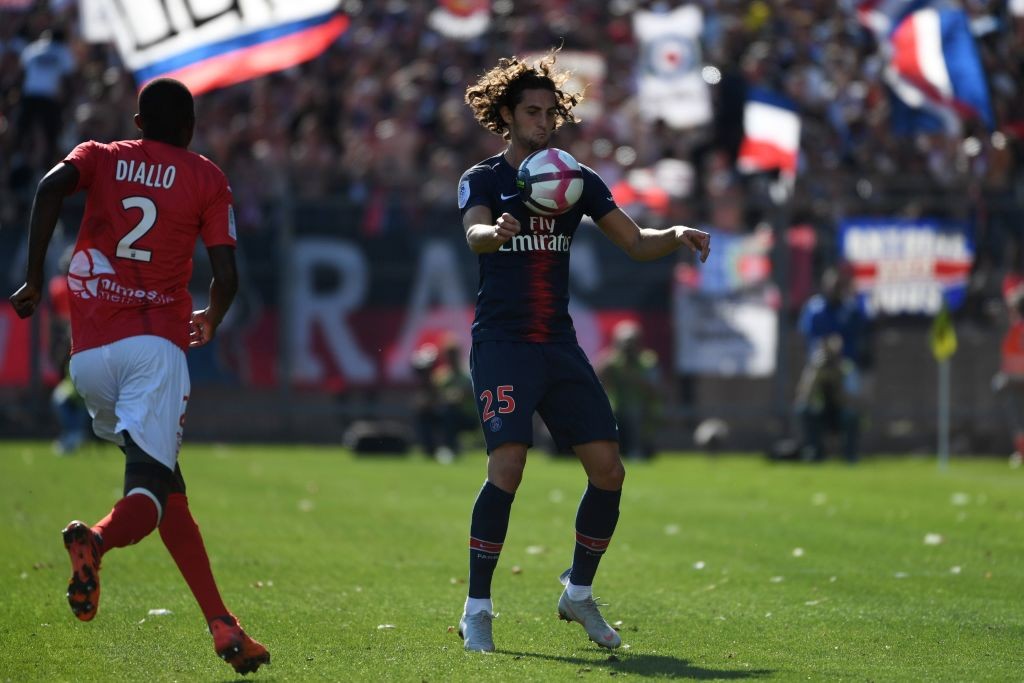 Paris Saint-Germain's French midfielder Adrien Rabiot (R) controls the ball during the French L1 football match between Nimes and Paris Saint-Germain (PSG), on September 1, 2018 at the Costieres stadium in Nimes, southern France. (Photo by Pascal GUYOT / AFP) (Photo credit should read PASCAL GUYOT/AFP/Getty Images)