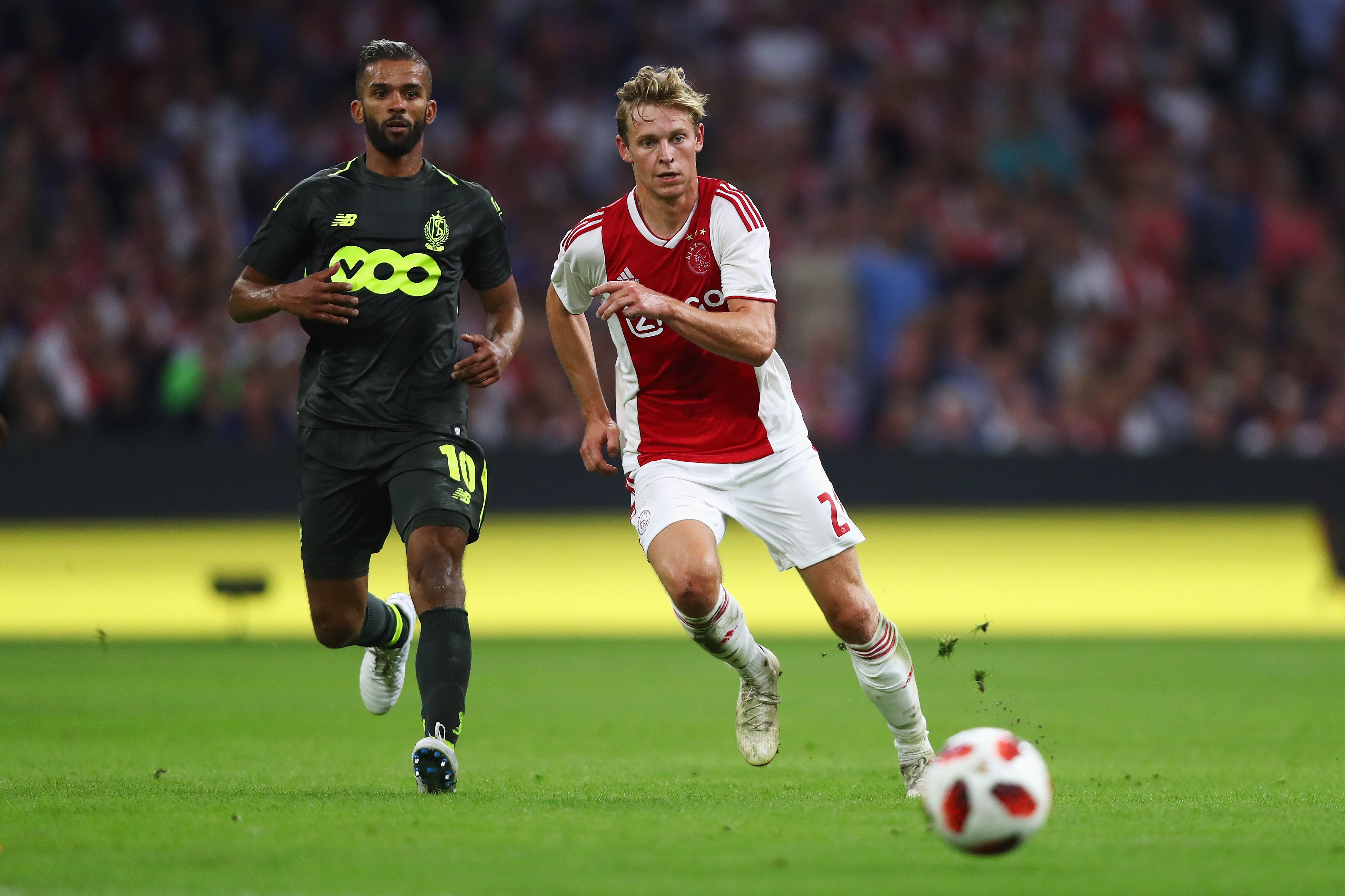 AMSTERDAM, NETHERLANDS - AUGUST 14:  Frenkie de Jong of Ajax battles for the ball with Mehdi Carcela-Gonzalez of Standard de Liege during the UEFA Champions League third round qualifying match between Ajax and Royal Standard de Liege at Johan Cruyff Arena on August 14, 2018 in Amsterdam, Netherlands.  (Photo by Dean Mouhtaropoulos/Getty Images)