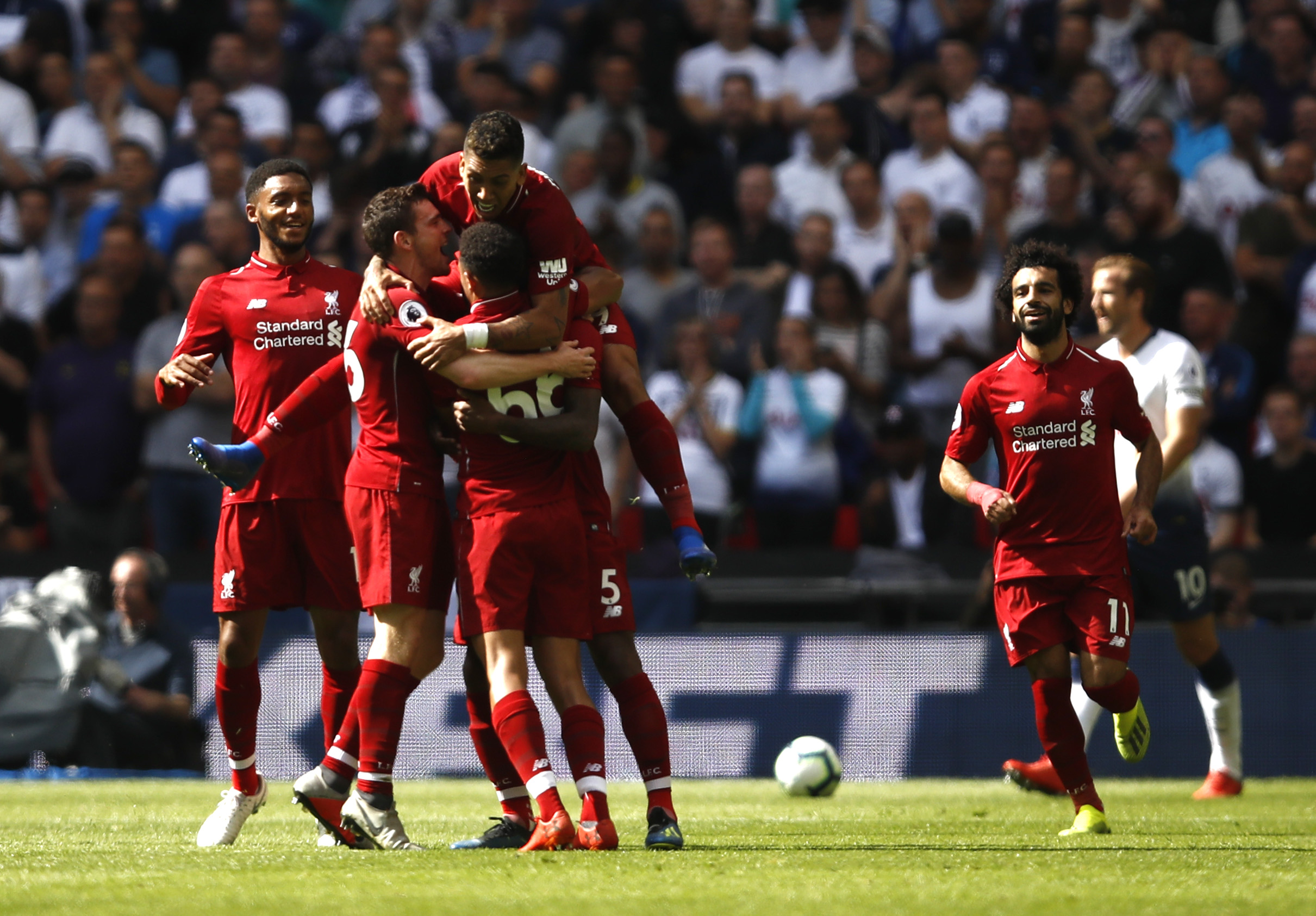 LONDON, ENGLAND - SEPTEMBER 15:  Georginio Wijnaldum of Liverpool celebrates with teammates after scoring his team's first goal during the Premier League match between Tottenham Hotspur and Liverpool FC at Wembley Stadium on September 15, 2018 in London, United Kingdom.  (Photo by Julian Finney/Getty Images)