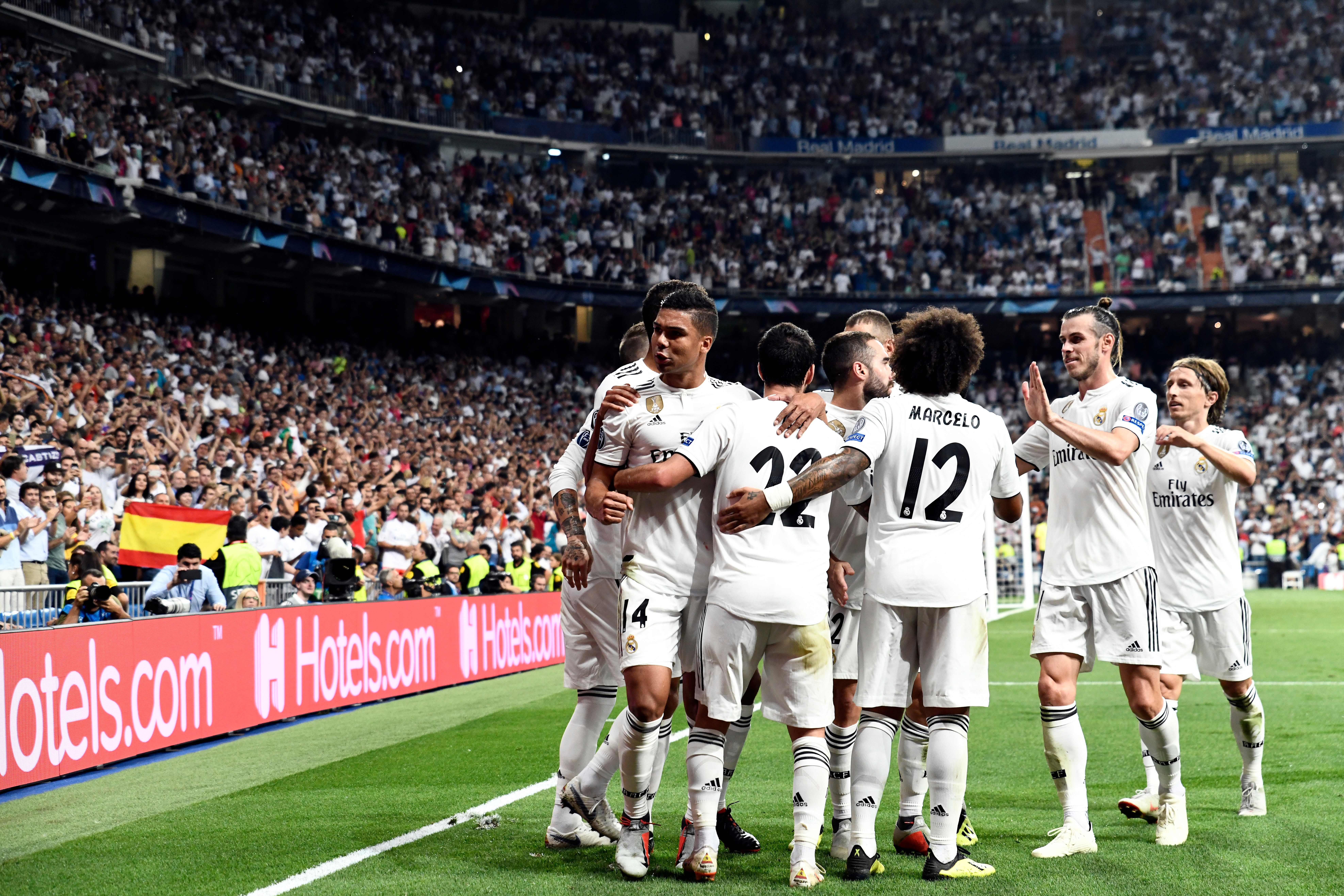 Real Madrid players celebrate the opening goal during the UEFA Champions League group G football match between Real Madrid CF and AS Roma at the Santiago Bernabeu stadium in Madrid on September 19, 2018. (Photo by OSCAR DEL POZO / AFP)        (Photo credit should read OSCAR DEL POZO/AFP/Getty Images)