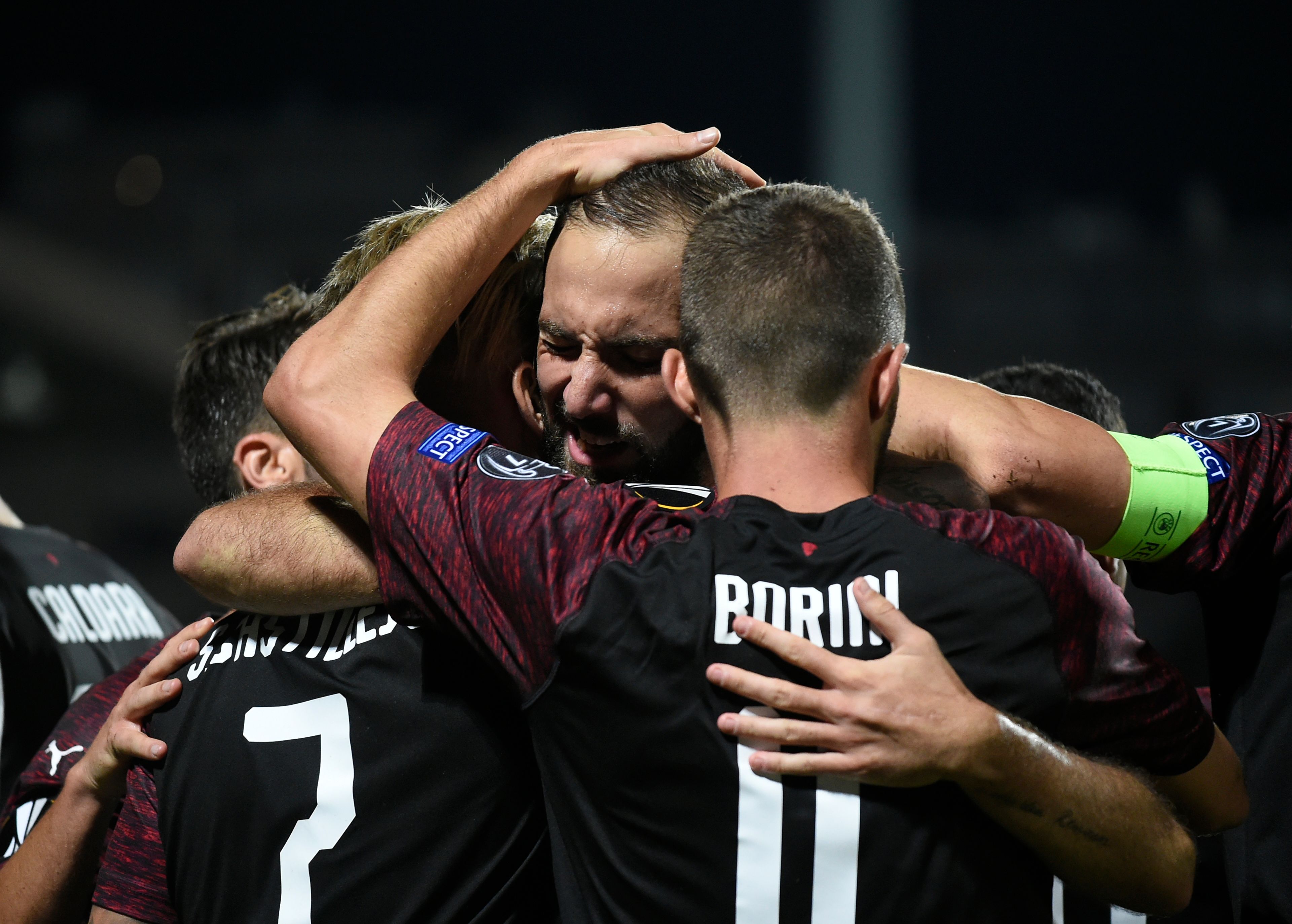 AC Milan's Argentinian forward Gonzalo Higuain (L) celebrates after scoring a goal during the UEFA Europa League Group F football match between F91 Dudelange and AC Milan at the Josy Barthel Stadium in Luxembourg, on September 20, 2018. (Photo by JOHN THYS / AFP)        (Photo credit should read JOHN THYS/AFP/Getty Images)