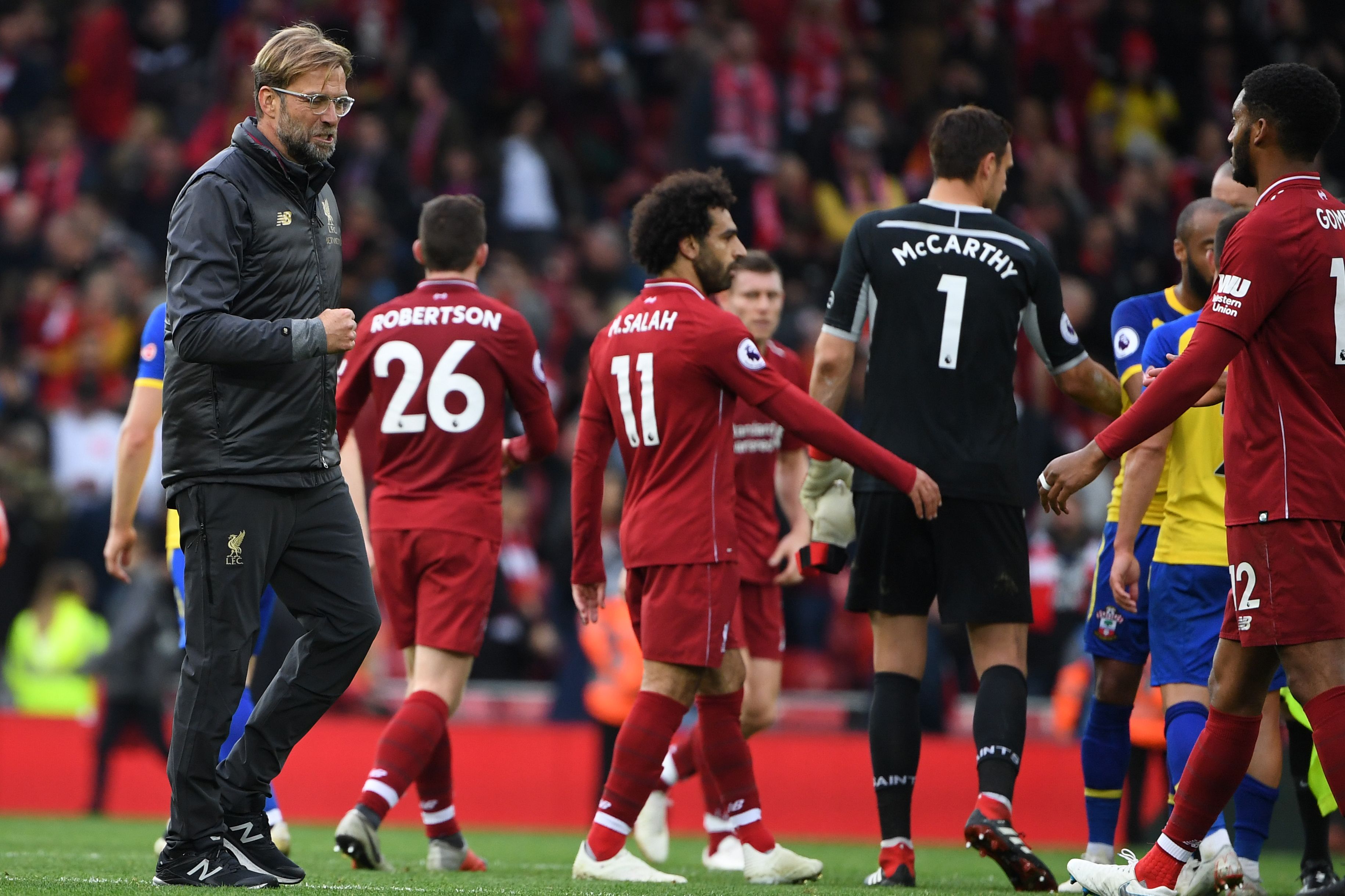 Liverpool's German manager Jurgen Klopp (L) gestures after the English Premier League football match between Liverpool and Southampton at Anfield in Liverpool, north west England on September 22, 2018. (Photo by Paul ELLIS / AFP) / RESTRICTED TO EDITORIAL USE. No use with unauthorized audio, video, data, fixture lists, club/league logos or 'live' services. Online in-match use limited to 120 images. An additional 40 images may be used in extra time. No video emulation. Social media in-match use limited to 120 images. An additional 40 images may be used in extra time. No use in betting publications, games or single club/league/player publications. /         (Photo credit should read PAUL ELLIS/AFP/Getty Images)