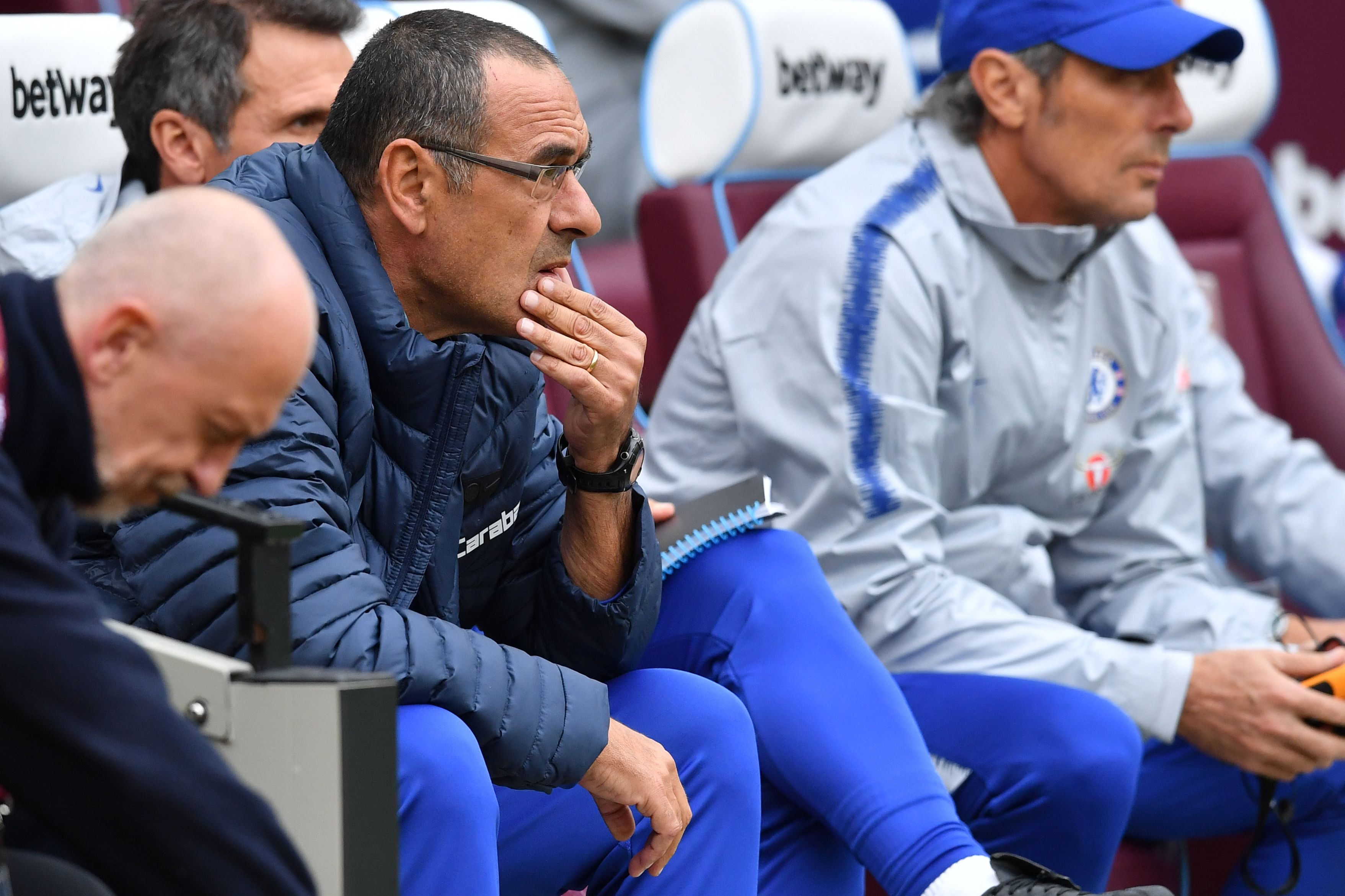 Chelsea's Italian head coach Maurizio Sarri awaits kick off in the English Premier League football match between West Ham United and Chelsea at The London Stadium, in east London on September 23, 2018. (Photo by Ben STANSALL / AFP) / RESTRICTED TO EDITORIAL USE. No use with unauthorized audio, video, data, fixture lists, club/league logos or 'live' services. Online in-match use limited to 120 images. An additional 40 images may be used in extra time. No video emulation. Social media in-match use limited to 120 images. An additional 40 images may be used in extra time. No use in betting publications, games or single club/league/player publications. /         (Photo credit should read BEN STANSALL/AFP/Getty Images)