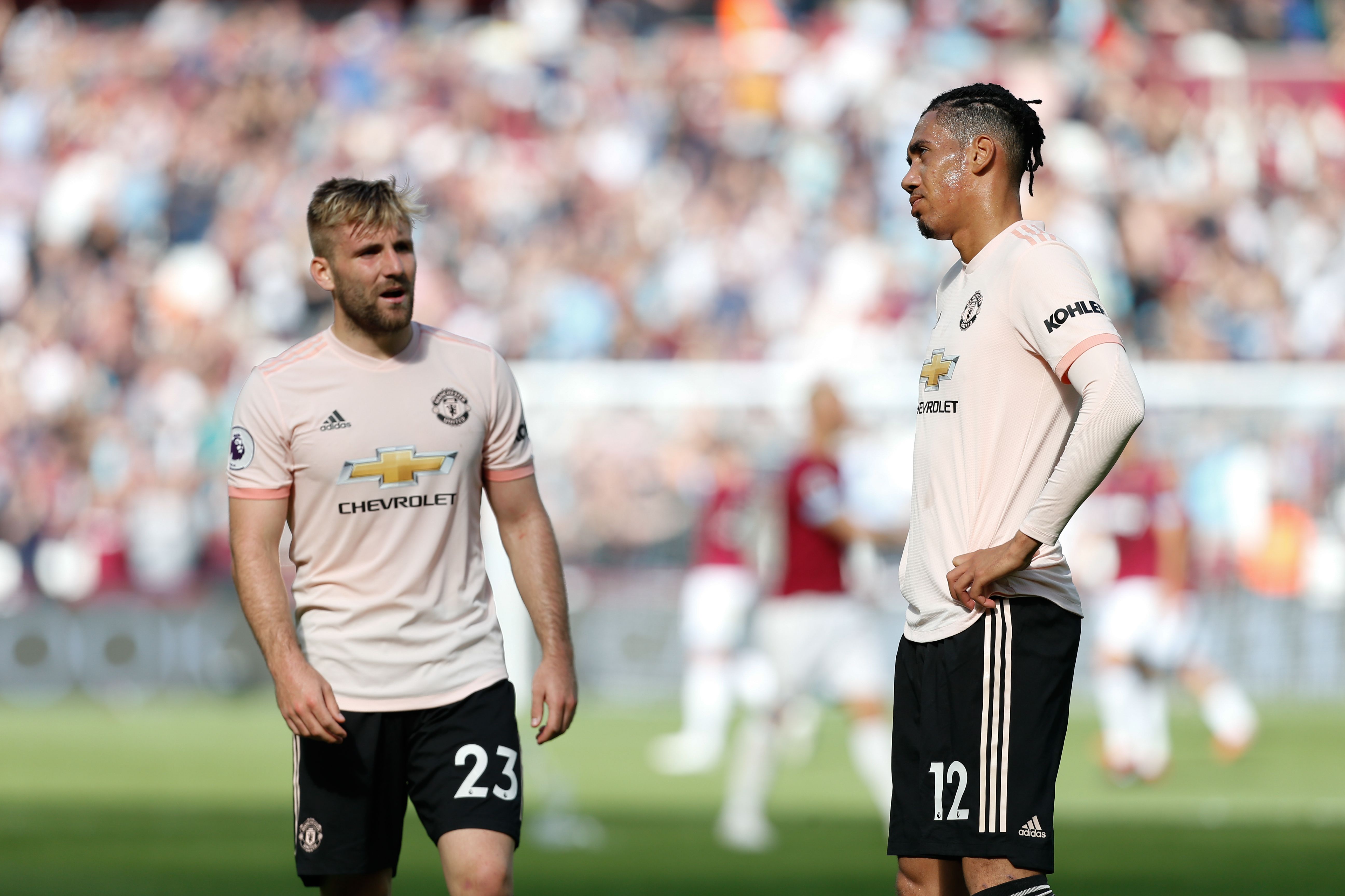 Manchester United's English defender Luke Shaw (L) and Manchester United's English defender Chris Smalling (R) react at the final whistle of the English Premier League football match between West Ham United and Manchester United at The London Stadium, in east London on September 29, 2018. (Photo by Ian KINGTON / AFP) / RESTRICTED TO EDITORIAL USE. No use with unauthorized audio, video, data, fixture lists, club/league logos or 'live' services. Online in-match use limited to 120 images. An additional 40 images may be used in extra time. No video emulation. Social media in-match use limited to 120 images. An additional 40 images may be used in extra time. No use in betting publications, games or single club/league/player publications. /         (Photo credit should read IAN KINGTON/AFP/Getty Images)