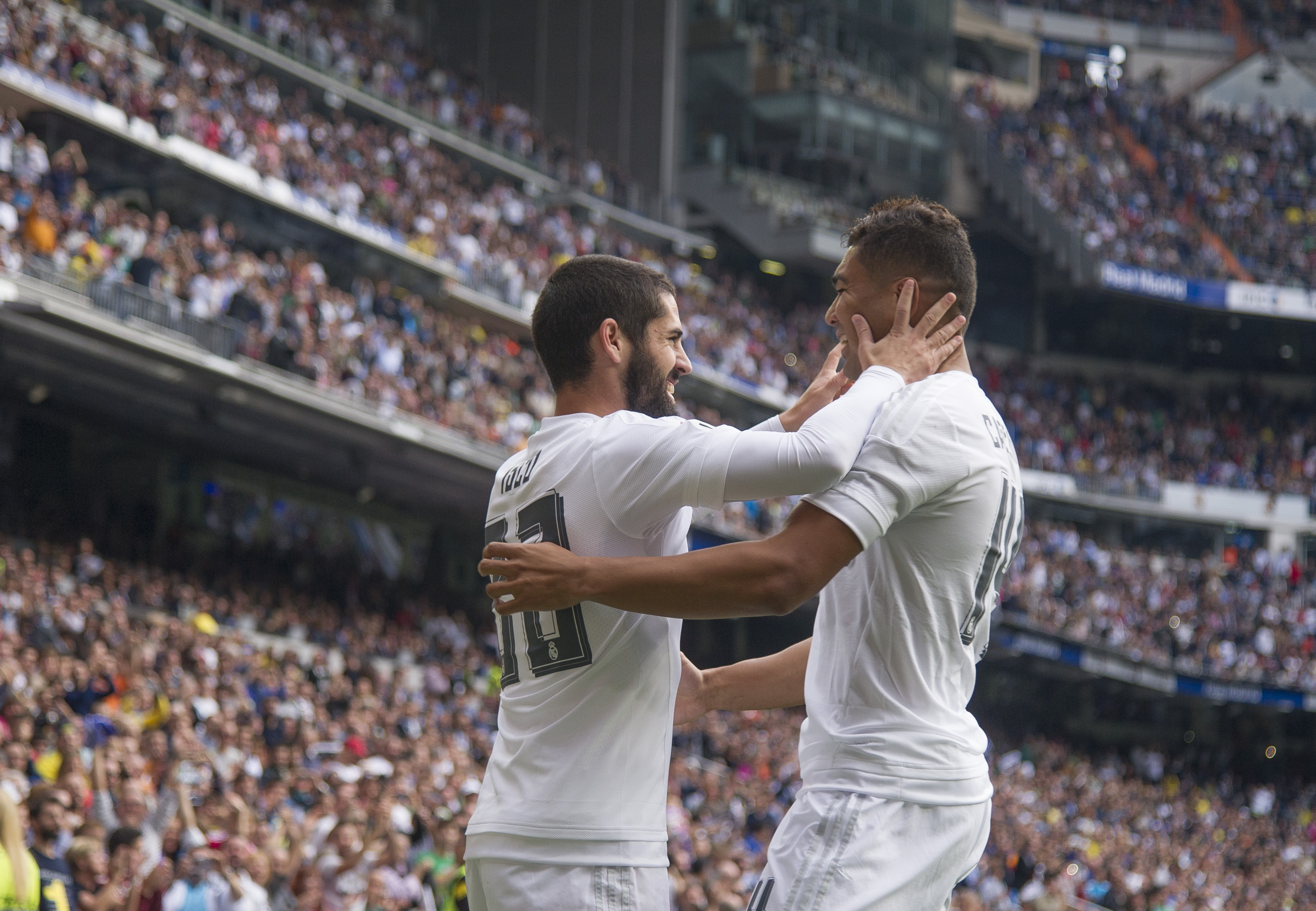 Real Madrid's midfielder Isco (L) celebrates a goal with Real Madrid's Brazilian midfielder Casimiro during the Spanish league football match Real Madrid CF vs UD Las Palmas at the Santiago Bernabeu stadium in Madrid on October 31, 2015.  AFP PHOTO / CURTO DE LA TORRE (Photo by CURTO DE LA TORRE / AFP)        (Photo credit should read CURTO DE LA TORRE/AFP/Getty Images)