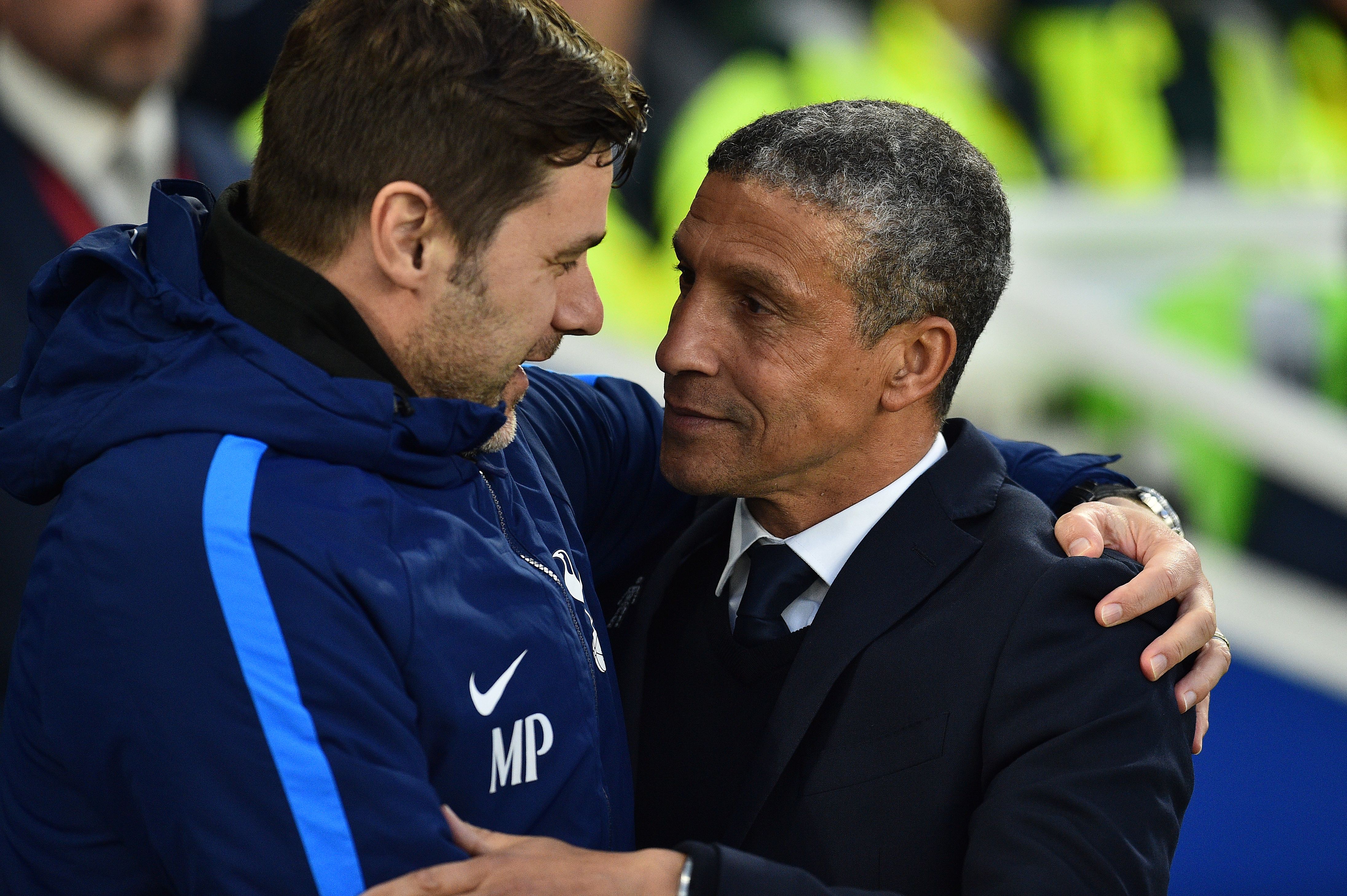 Tottenham Hotspur's Argentinian head coach Mauricio Pochettino (L) greets Brighton's Irish manager Chris Hughton ahead of the English Premier League football match between Brighton and Hove Albion and Tottenham Hotspur at the American Express Community Stadium in Brighton, southern England on April 17, 2018. / AFP PHOTO / Glyn KIRK / RESTRICTED TO EDITORIAL USE. No use with unauthorized audio, video, data, fixture lists, club/league logos or 'live' services. Online in-match use limited to 75 images, no video emulation. No use in betting, games or single club/league/player publications.  /         (Photo credit should read GLYN KIRK/AFP/Getty Images)
