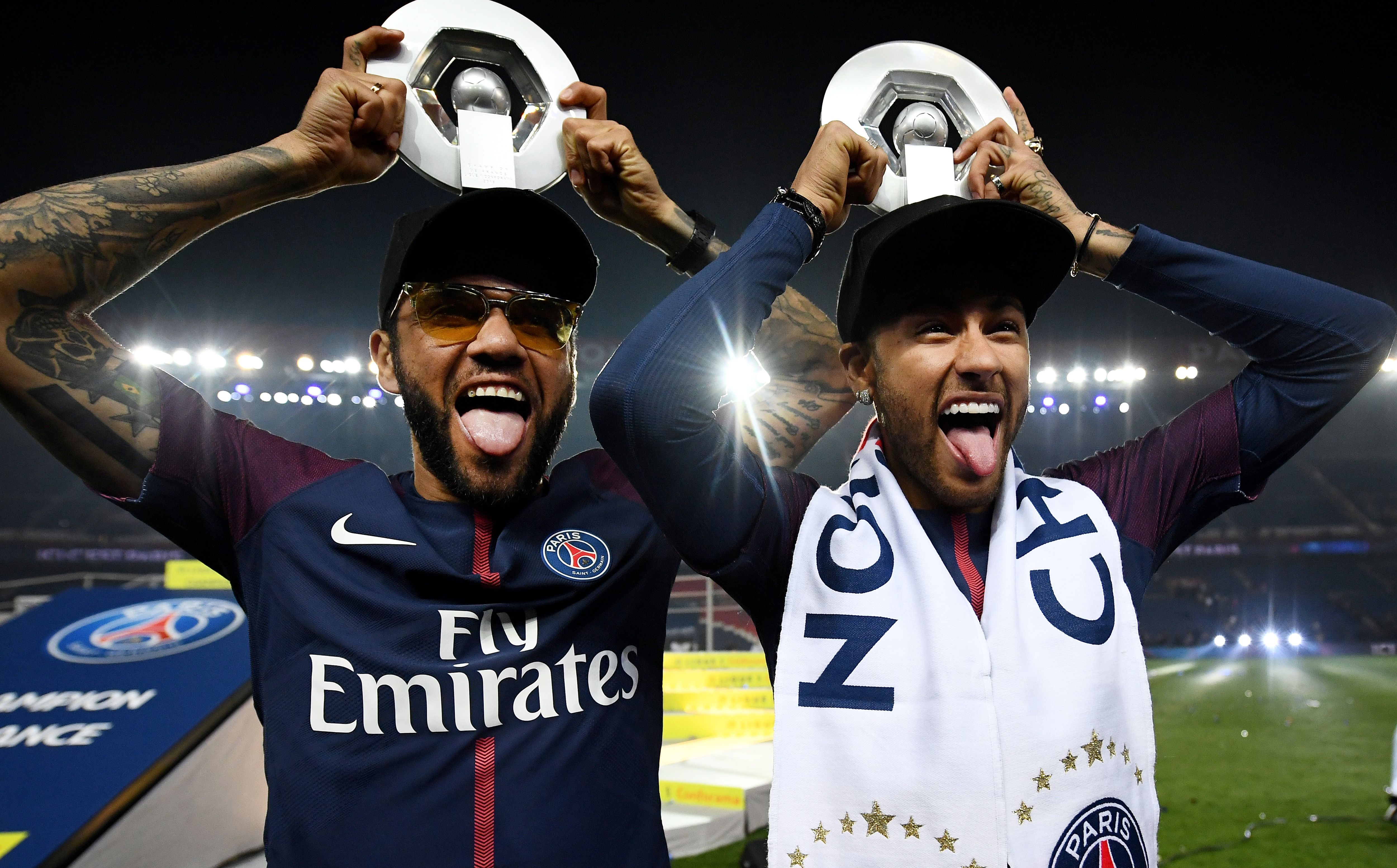 Paris Saint-Germain's Brazilian defender Dani Alves (L) and Paris Saint-Germain's Brazilian forward Neymar joke after winning the French L1 title at the end of the French L1 football match Paris Saint-Germain (PSG) vs Rennes on May 12, 2018 at the Parc des Princes stadium in Paris. (Photo by FRANCK FIFE / AFP)        (Photo credit should read FRANCK FIFE/AFP/Getty Images)