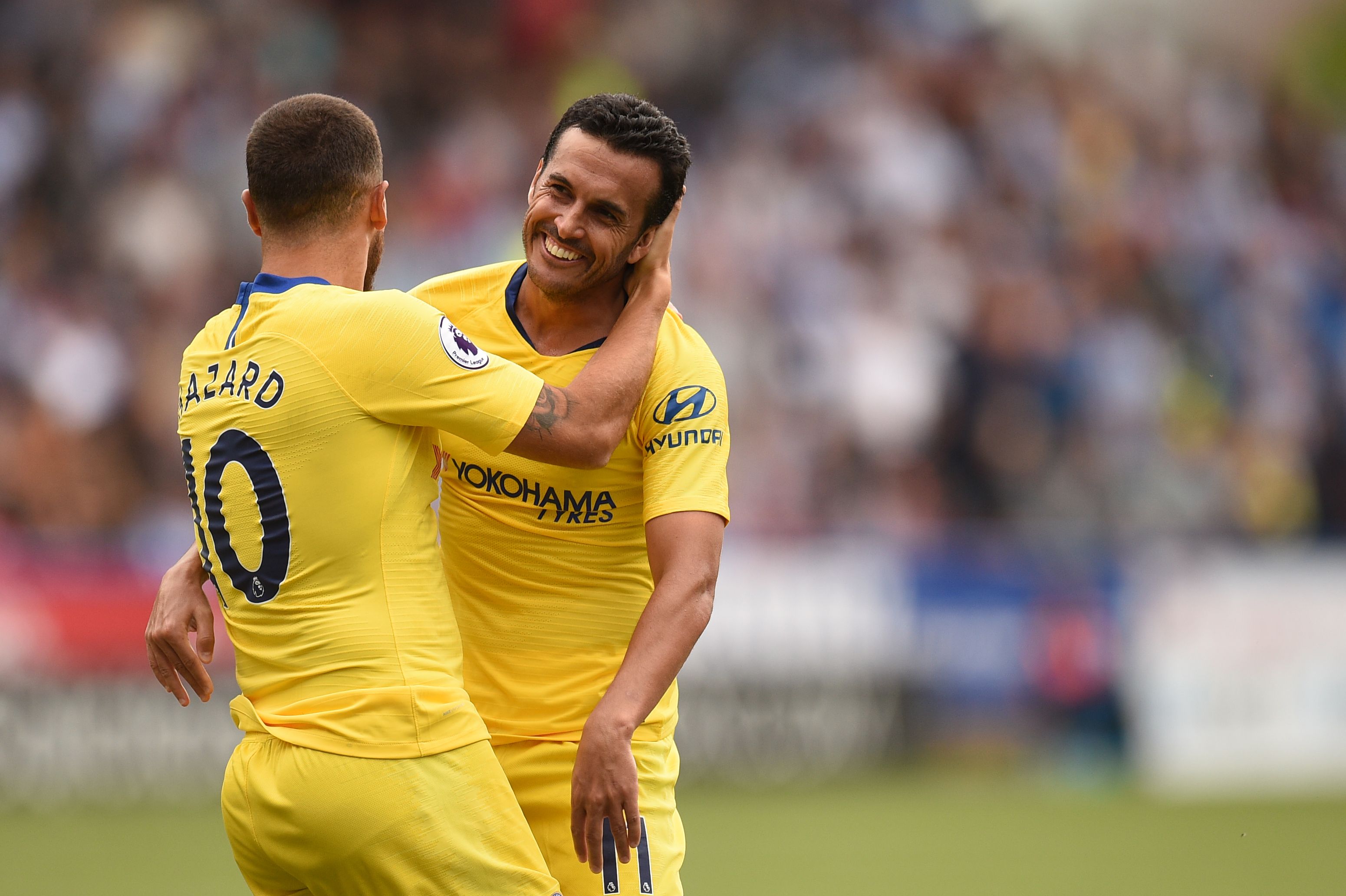 Chelsea's Spanish midfielder Pedro (R) celebrates with Chelsea's Belgian midfielder Eden Hazard after scoring the team's third goal past Huddersfield Town's English goalkeeper Ben Hamer during the English Premier League football match between Huddersfield Town and Chelsea at the John Smith's stadium in Huddersfield, northern England on August 11, 2018. (Photo by Oli SCARFF / AFP) / RESTRICTED TO EDITORIAL USE.No use with unauthorized audio, video, data, fixture lists, club/league logos or 'live' services. Online in-match use limited to 120 images. An additional 40 images may be used in extra time. No video emulation. Social media in-match use limited to 120 images. An additional 40 images may be used in extra time. No use in betting publications, games or single club/league/player publications/ /         (Photo credit should read OLI SCARFF/AFP/Getty Images)