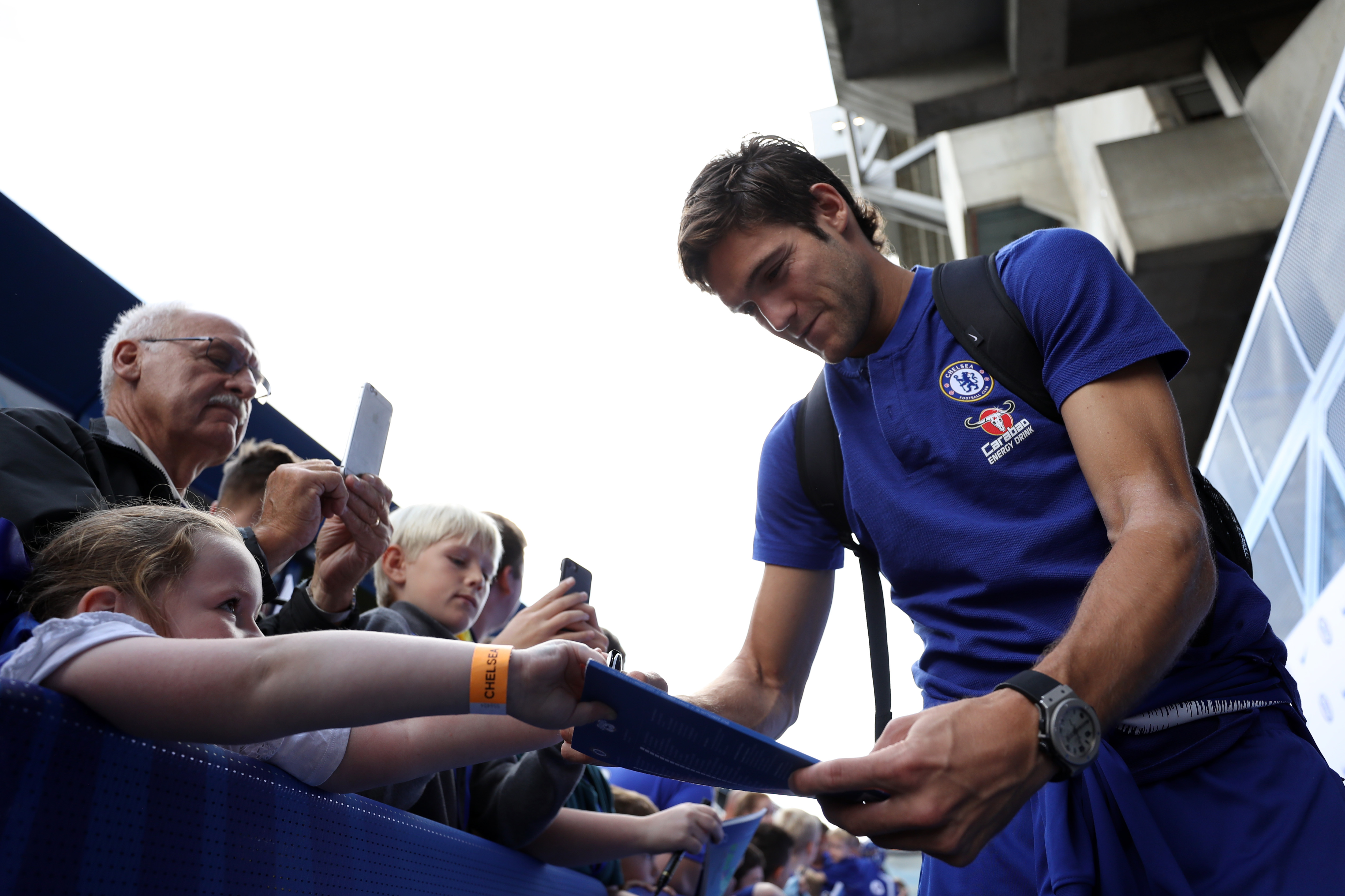 LONDON, ENGLAND - SEPTEMBER 15:  Marcos Alonso of Chelsea signs autographs ahead of the Premier League match between Chelsea FC and Cardiff City at Stamford Bridge on September 15, 2018 in London, United Kingdom.  (Photo by Dan Istitene/Getty Images)