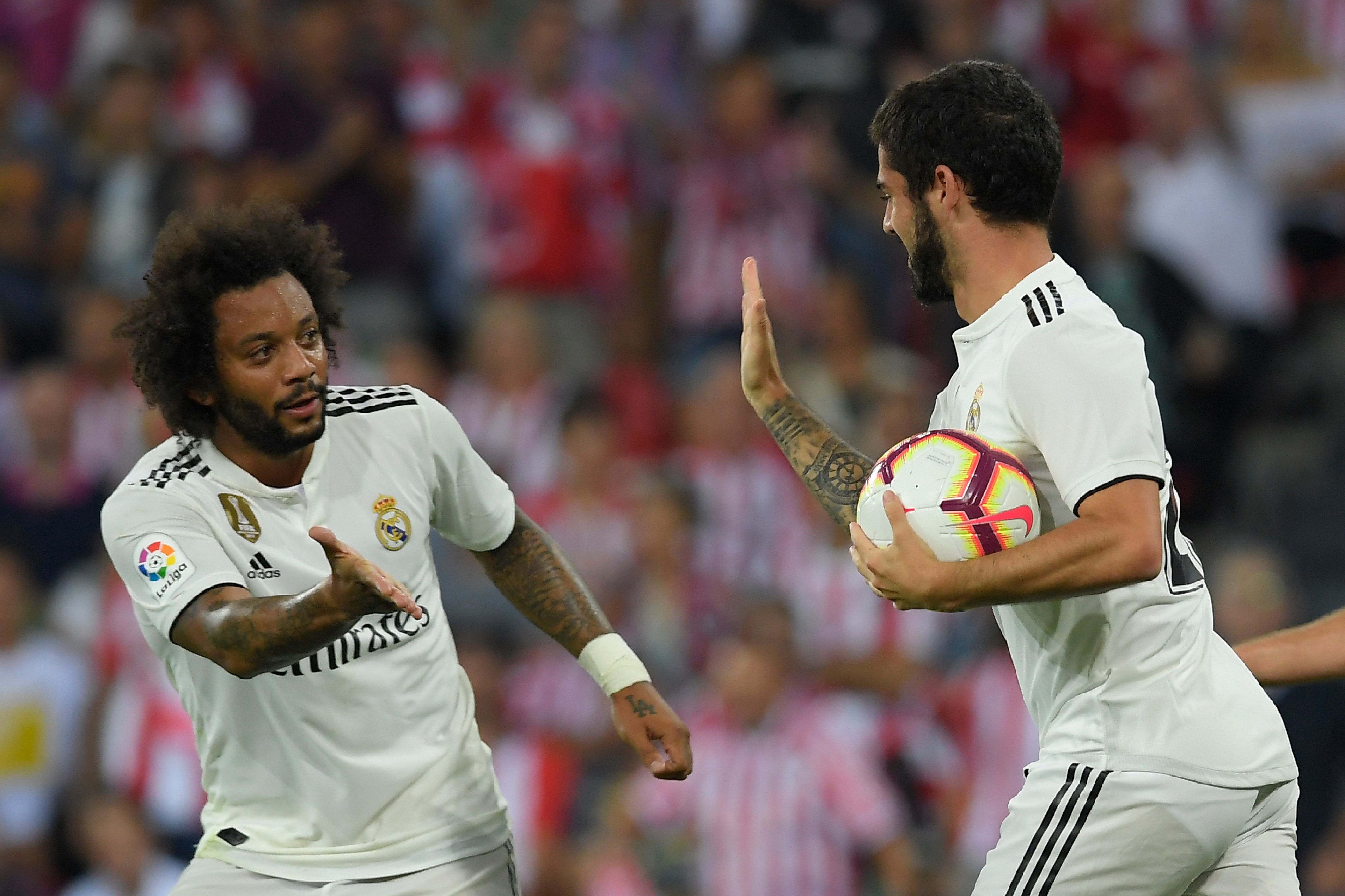Real Madrid's Spanish midfielder Isco (R) celebrates with Real Madrid's Brazilian defender Marcelo after scoring during the Spanish league football match between Athletic Club Bilbao and Real Madrid CF at the San Mames stadium in Bilbao on September 15, 2018. (Photo by LLUIS GENE / AFP)        (Photo credit should read LLUIS GENE/AFP/Getty Images)