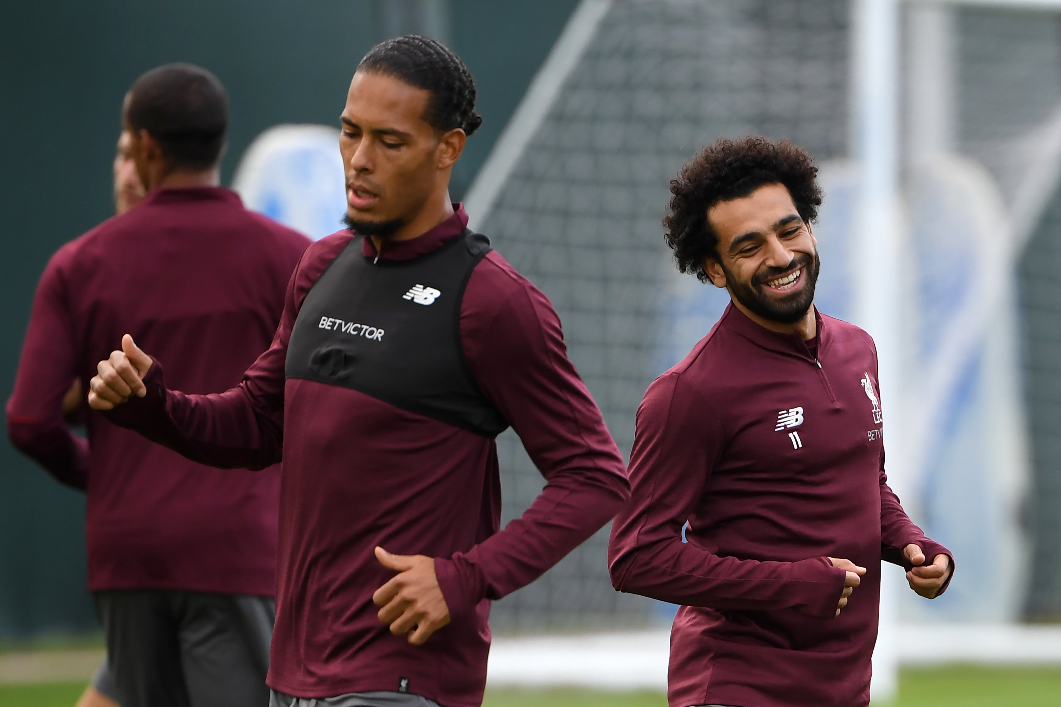 Liverpool's Egyptian midfielder Mohamed Salah (R) and Liverpool's Dutch defender Virgil van Dijk attend a team training session at their Melwood training complex in Liverpool, north west England, on September 17, 2018, on the eve of their UEFA Champions League group C football match against Paris Saint-Germain. (Photo by Paul ELLIS / AFP)        (Photo credit should read PAUL ELLIS/AFP/Getty Images)