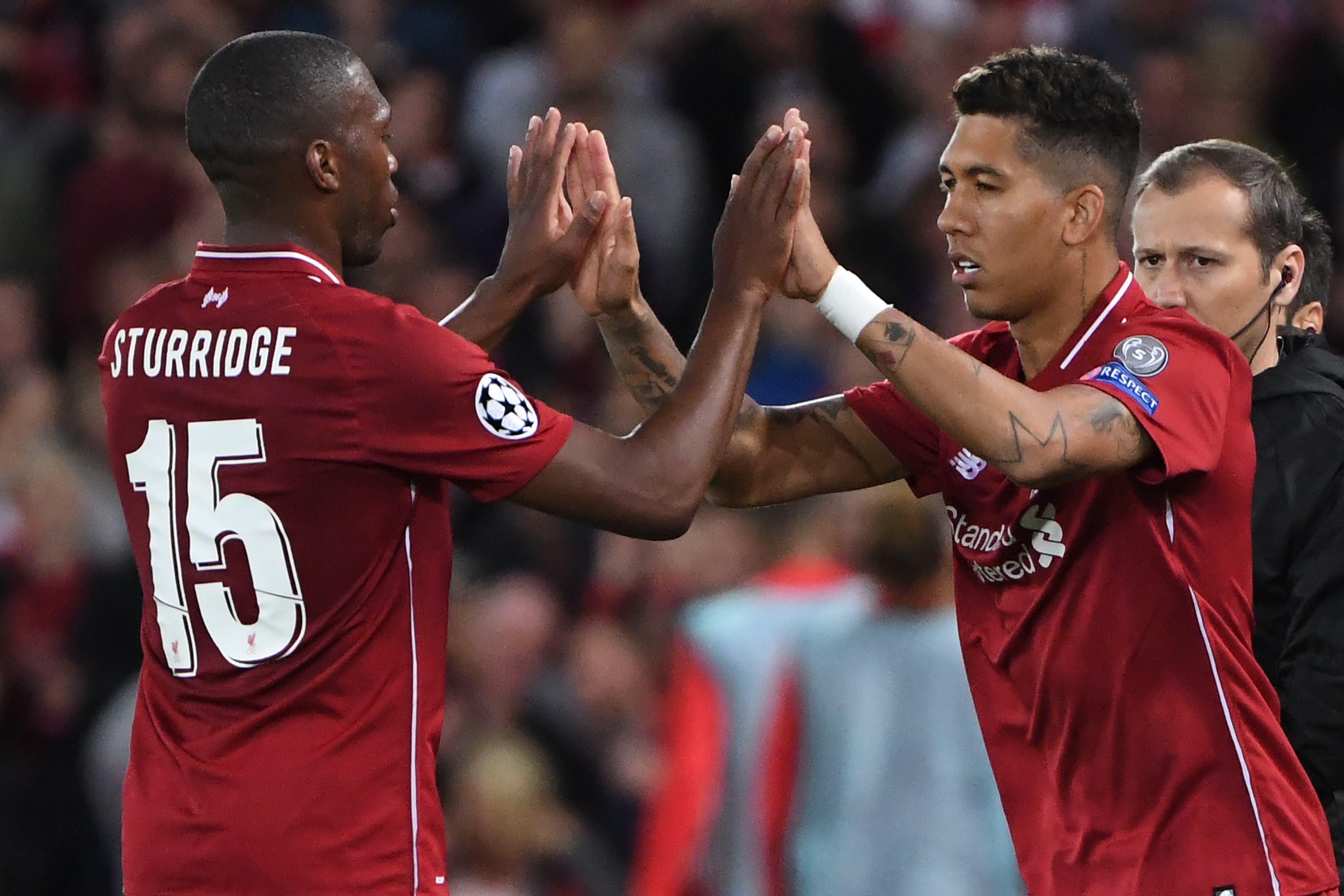 TOPSHOT - Liverpool's Brazilian midfielder Roberto Firmino (R) replaces Liverpool's English striker Daniel Sturridge during the UEFA Champions League group C football match between Liverpool and Paris Saint-Germain at Anfield in Liverpool, north west England on September 18, 2018. (Photo by Paul ELLIS / AFP)        (Photo credit should read PAUL ELLIS/AFP/Getty Images)