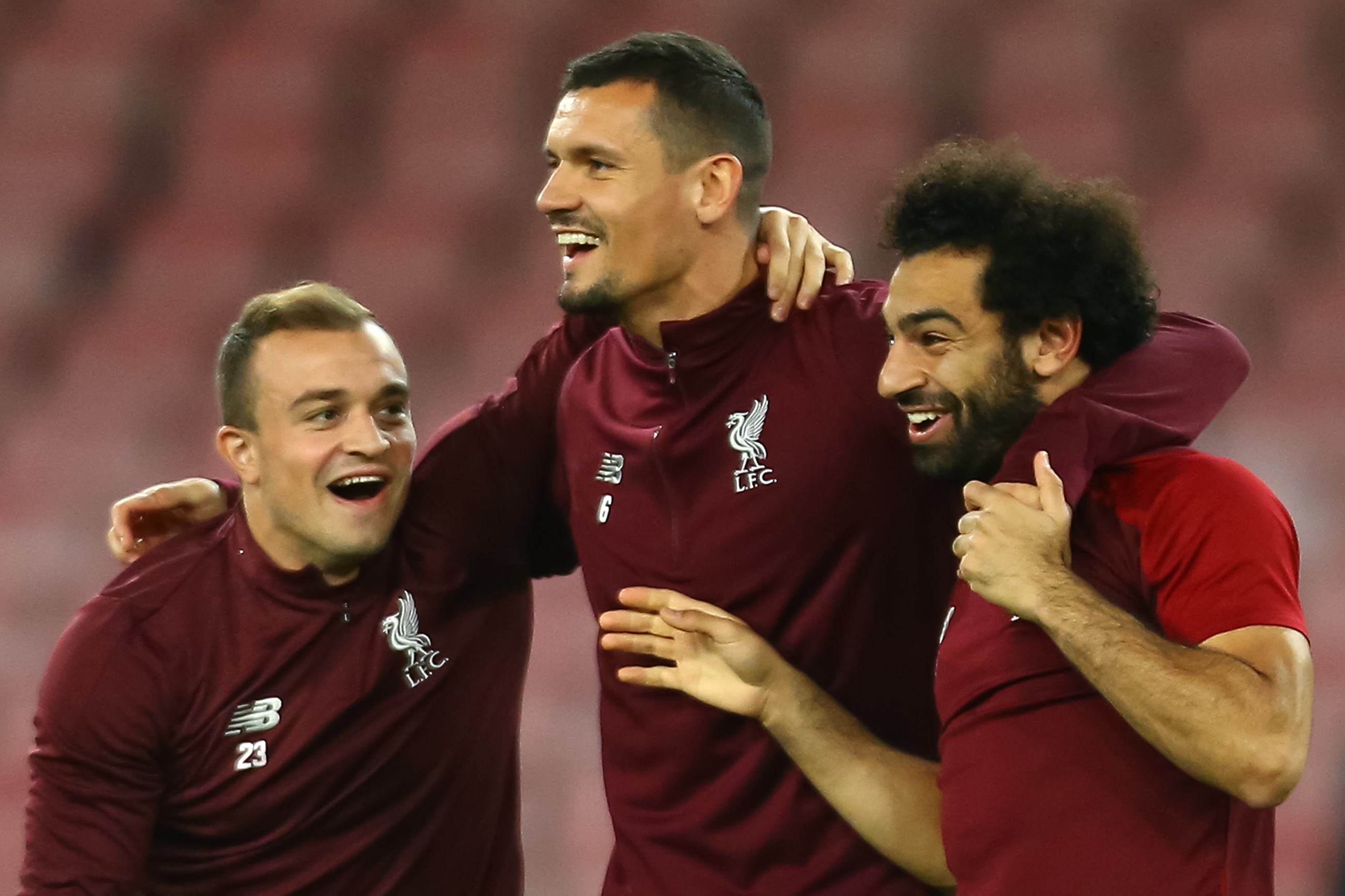 (From L) Liverpool's Swiss midfielder Xherdan Shaqiri, Liverpool's Croatian defender Dejan Lovren and Liverpool's Egyptian forward Mohamed Salah joke during a training session on the eve of the UEFA Champions League Group C football match Napoli vs Liverpool, on October 2, 2018 at the San Paolo stadium in Naples. (Photo by CARLO HERMANN / AFP)        (Photo credit should read CARLO HERMANN/AFP/Getty Images)