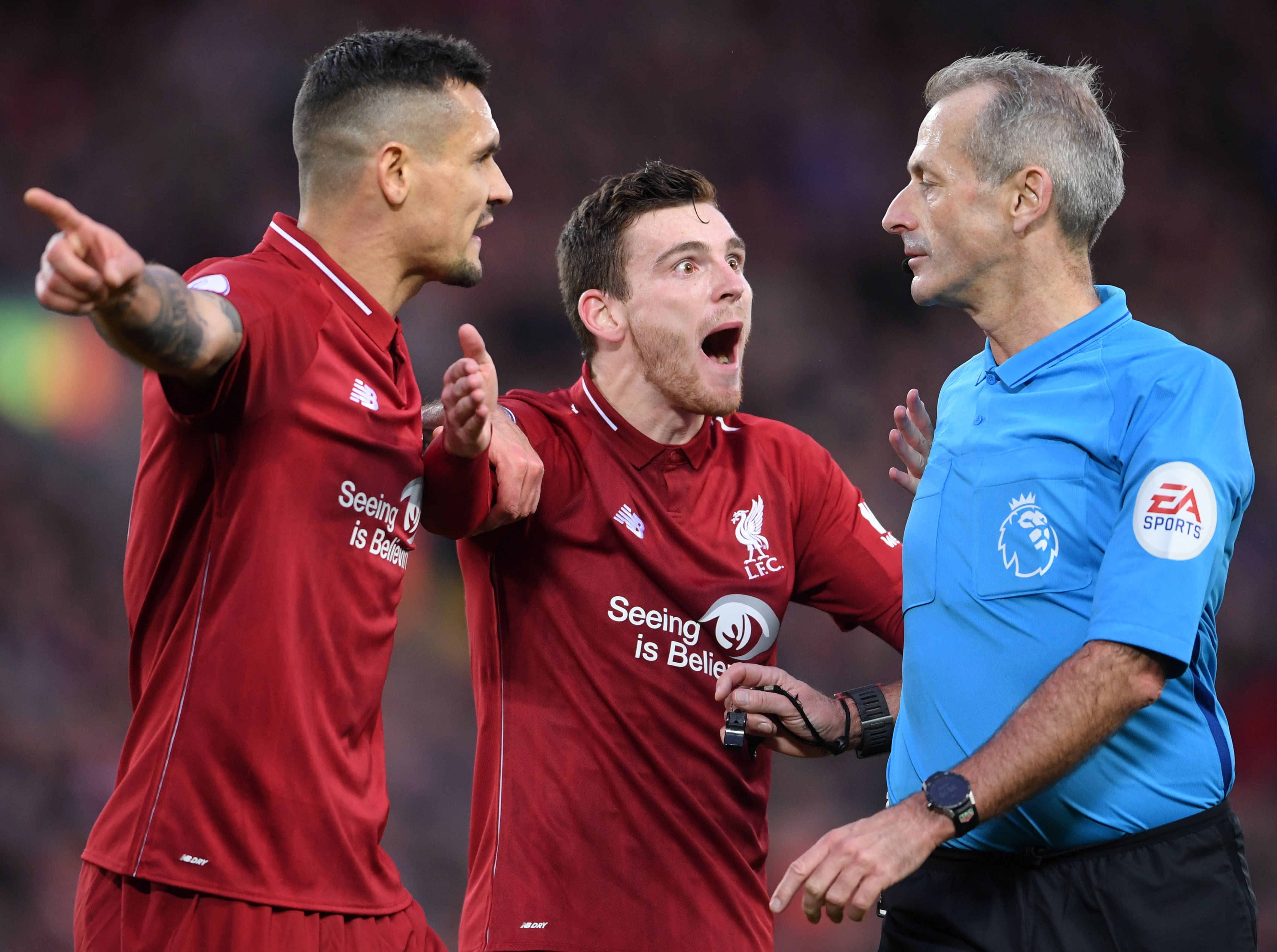 LIVERPOOL, ENGLAND - OCTOBER 07: Dejan Lovren and Andrew Roberton of Liverpool argue with Referee, Martin Atkinson during the Premier League match between Liverpool FC and Manchester City at Anfield on October 07, 2018 in Liverpool, United Kingdom. (Photo by Laurence Griffiths/Getty Images)