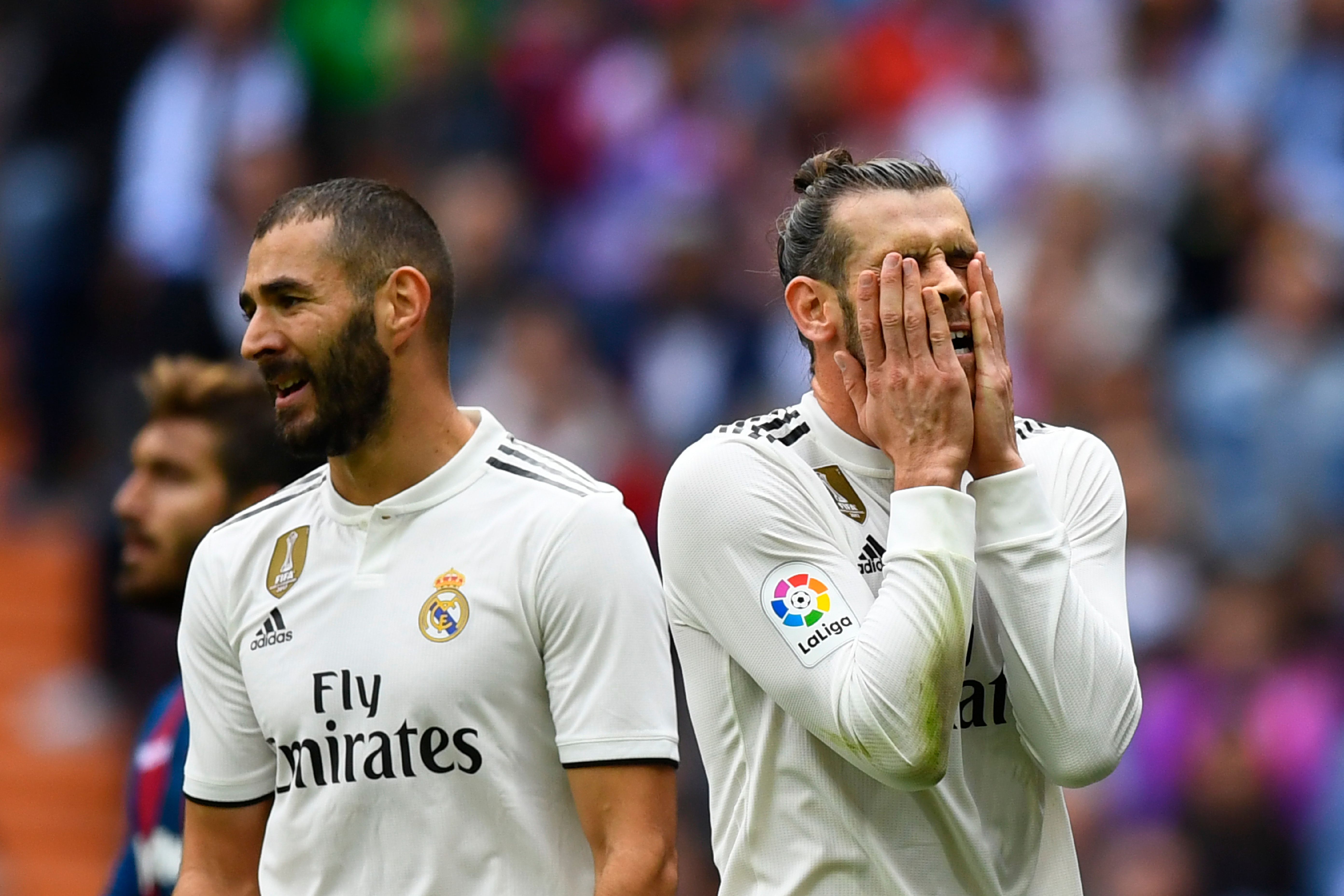 Real Madrid's Welsh forward Gareth Bale (R) reacts next to Real Madrid's French forward Karim Benzema during the Spanish league football match Real Madrid CF against Levante UD at the Santiago Bernabeu stadium in Madrid on October 20, 2018. (Photo by GABRIEL BOUYS / AFP)        (Photo credit should read GABRIEL BOUYS/AFP/Getty Images)