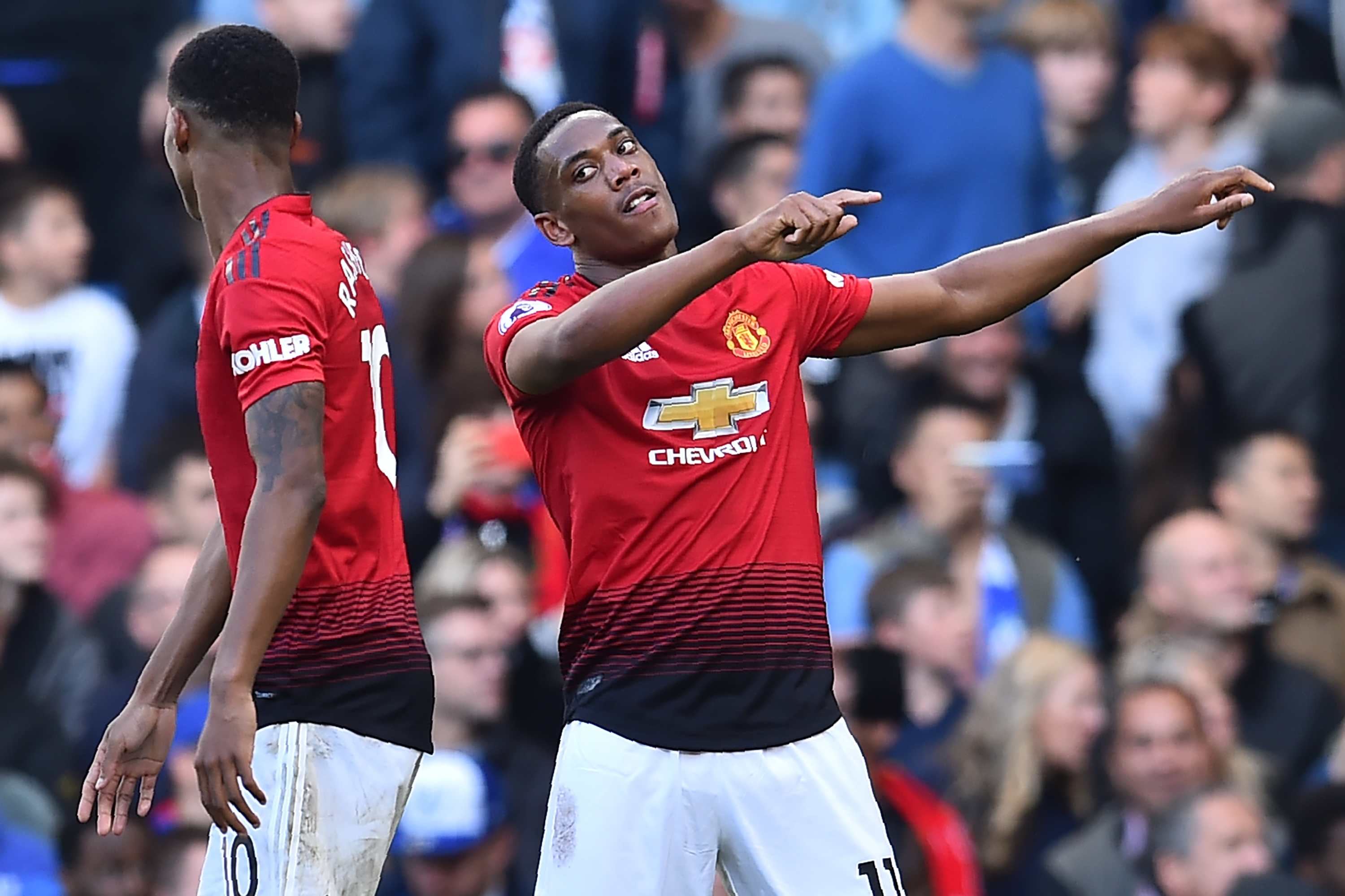 Manchester United's French striker Anthony Martial (R) celebrates with Manchester United's English striker Marcus Rashford (L) after scoring their second goal during the English Premier League football match between Chelsea and Manchester United at Stamford Bridge in London on October 20, 2018. (Photo by Glyn KIRK / AFP) / RESTRICTED TO EDITORIAL USE. No use with unauthorized audio, video, data, fixture lists, club/league logos or 'live' services. Online in-match use limited to 120 images. An additional 40 images may be used in extra time. No video emulation. Social media in-match use limited to 120 images. An additional 40 images may be used in extra time. No use in betting publications, games or single club/league/player publications. /         (Photo credit should read GLYN KIRK/AFP/Getty Images)