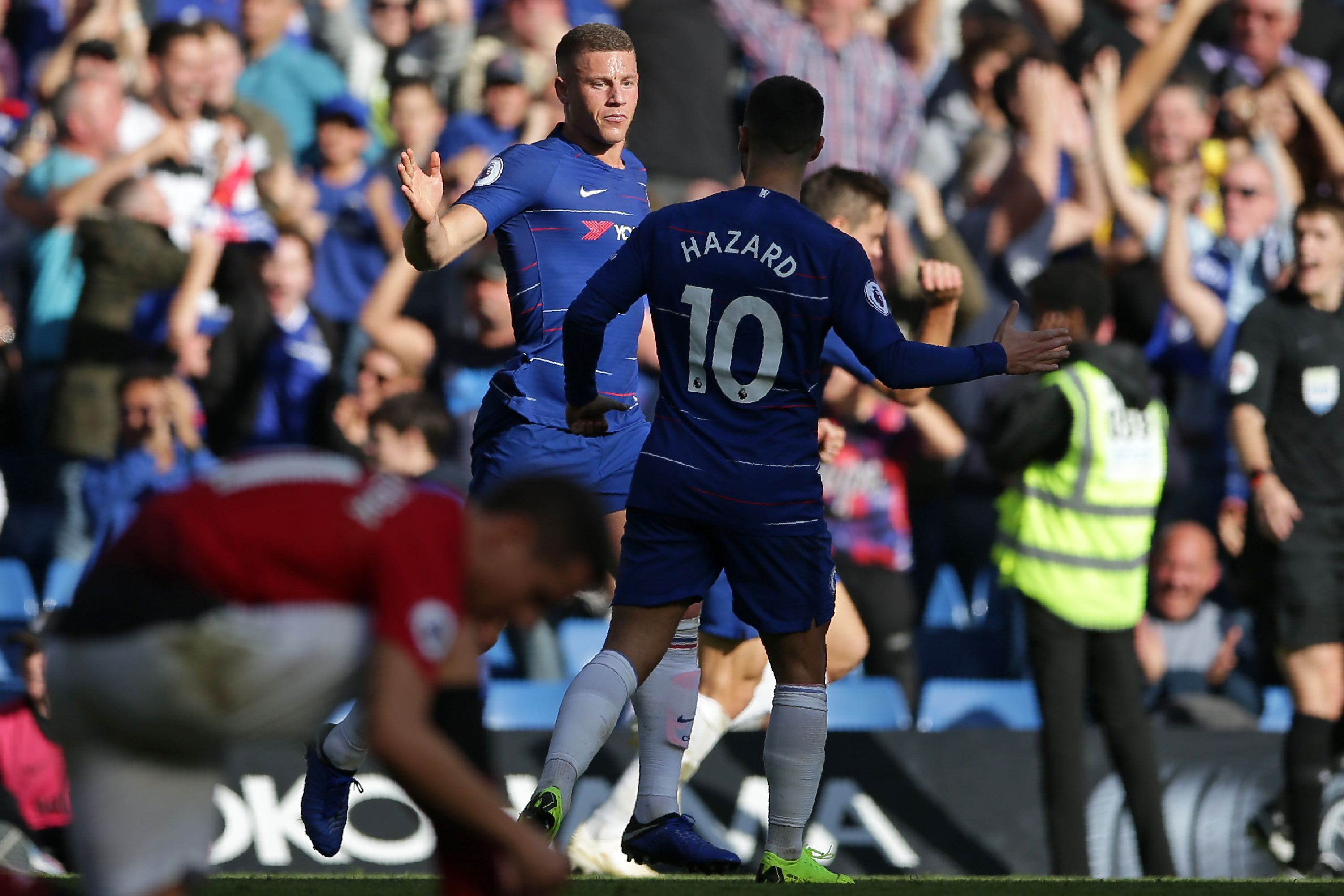 Chelsea's English midfielder Ross Barkley (C) celebrates with Chelsea's Belgian midfielder Eden Hazard after scoring their second goal during the English Premier League football match between Chelsea and Manchester United at Stamford Bridge in London on October 20, 2018. - The game finished 2-2. (Photo by Daniel LEAL-OLIVAS / AFP) / RESTRICTED TO EDITORIAL USE. No use with unauthorized audio, video, data, fixture lists, club/league logos or 'live' services. Online in-match use limited to 120 images. An additional 40 images may be used in extra time. No video emulation. Social media in-match use limited to 120 images. An additional 40 images may be used in extra time. No use in betting publications, games or single club/league/player publications. /         (Photo credit should read DANIEL LEAL-OLIVAS/AFP/Getty Images)