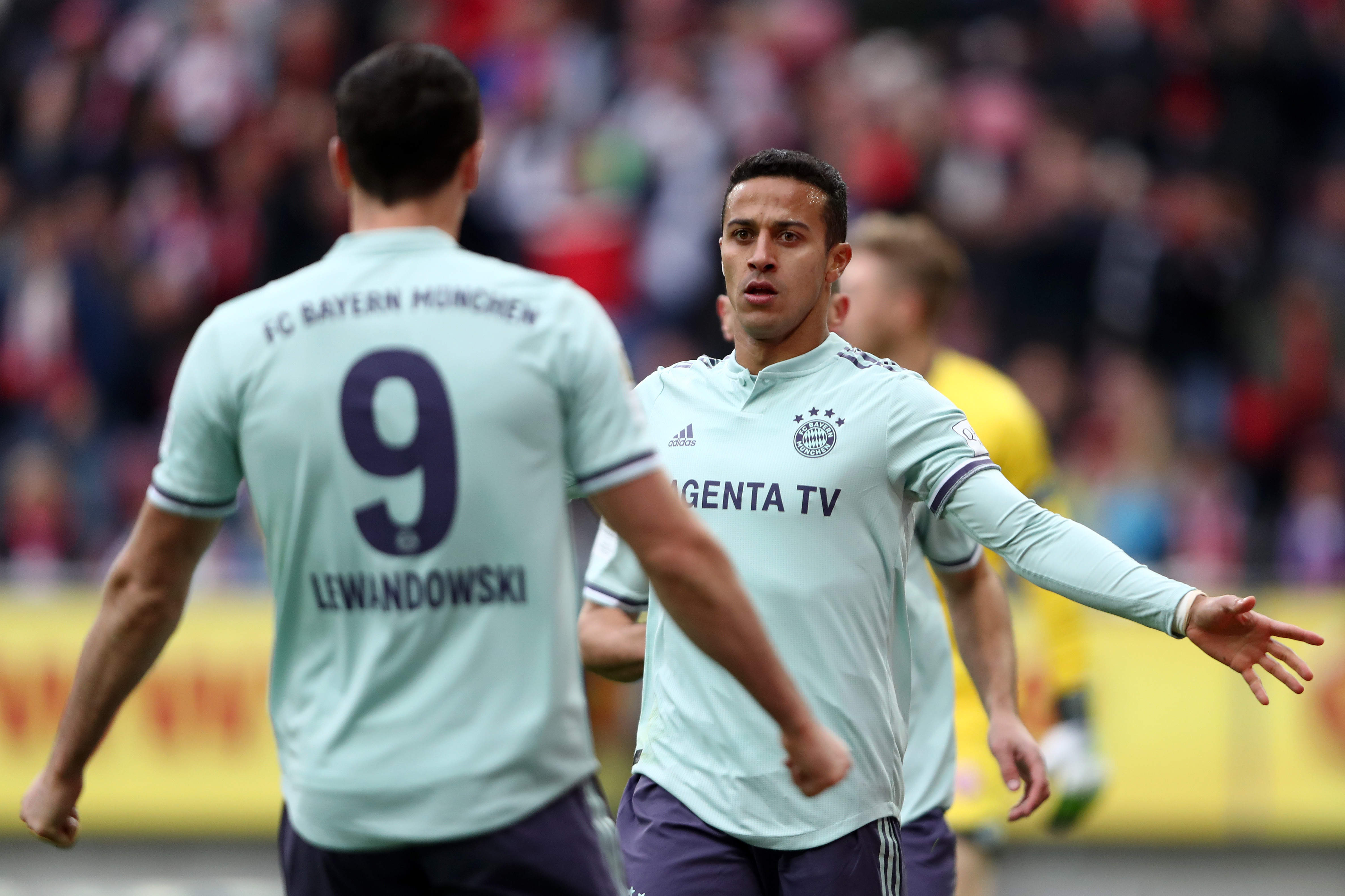 MAINZ, GERMANY - OCTOBER 27:  Thiago Alcantara of Bayern Munich celebrates with teammate Robert Lewandowski after scoring his team's second goal during the Bundesliga match between 1. FSV Mainz 05 and FC Bayern Muenchen at Opel Arena on October 27, 2018 in Mainz, Germany.  (Photo by Alex Grimm/Bongarts/Getty Images)