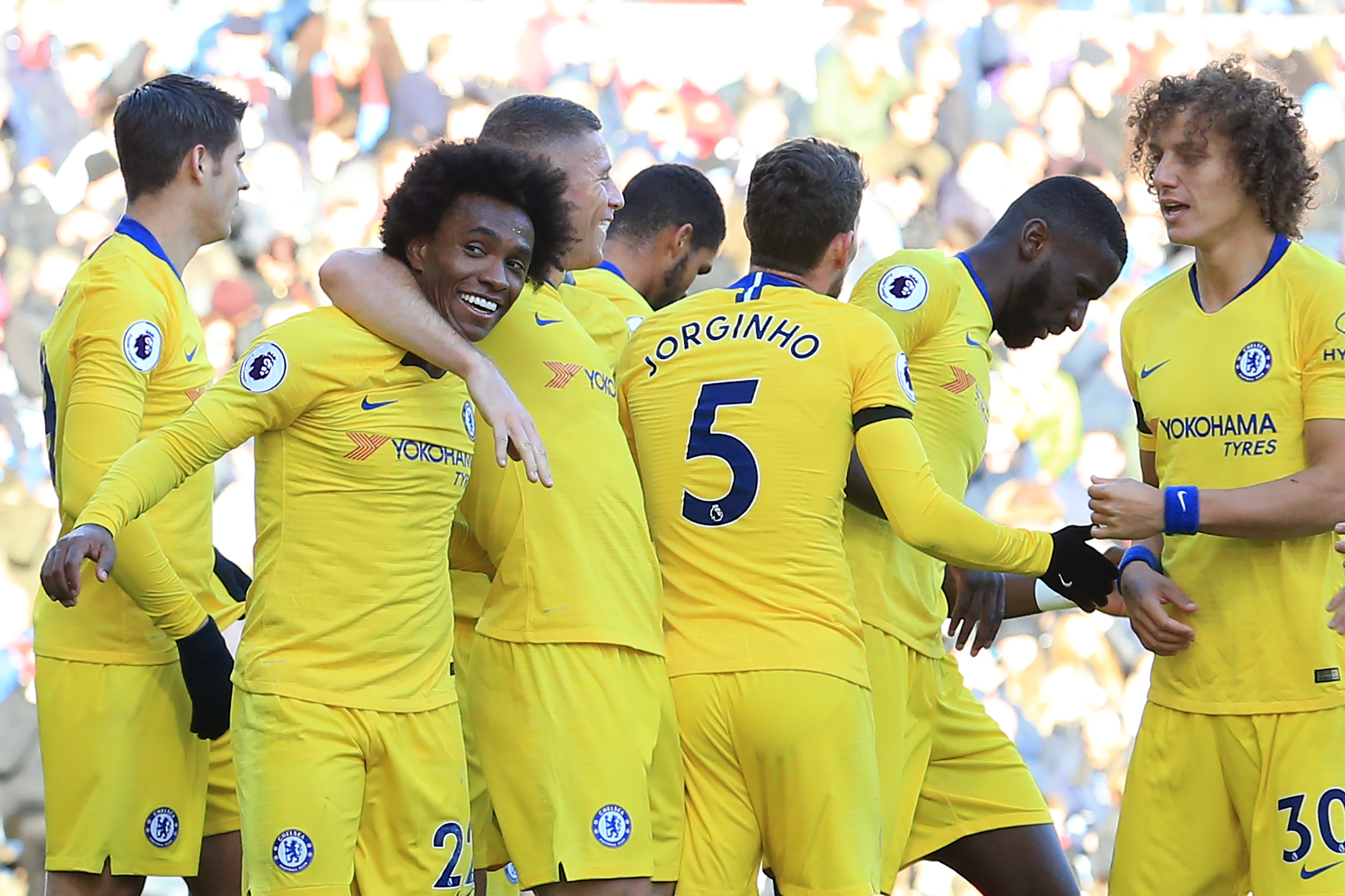 Chelsea's Brazilian midfielder Willian (2nd L) celebrates with teammates after scoring their third goal during the English Premier League football match between Burnley and Chelsea at Turf Moor in Burnley, north west England on October 28, 2018. (Photo by Lindsey PARNABY / AFP) / RESTRICTED TO EDITORIAL USE. No use with unauthorized audio, video, data, fixture lists, club/league logos or 'live' services. Online in-match use limited to 120 images. An additional 40 images may be used in extra time. No video emulation. Social media in-match use limited to 120 images. An additional 40 images may be used in extra time. No use in betting publications, games or single club/league/player publications. /         (Photo credit should read LINDSEY PARNABY/AFP/Getty Images)