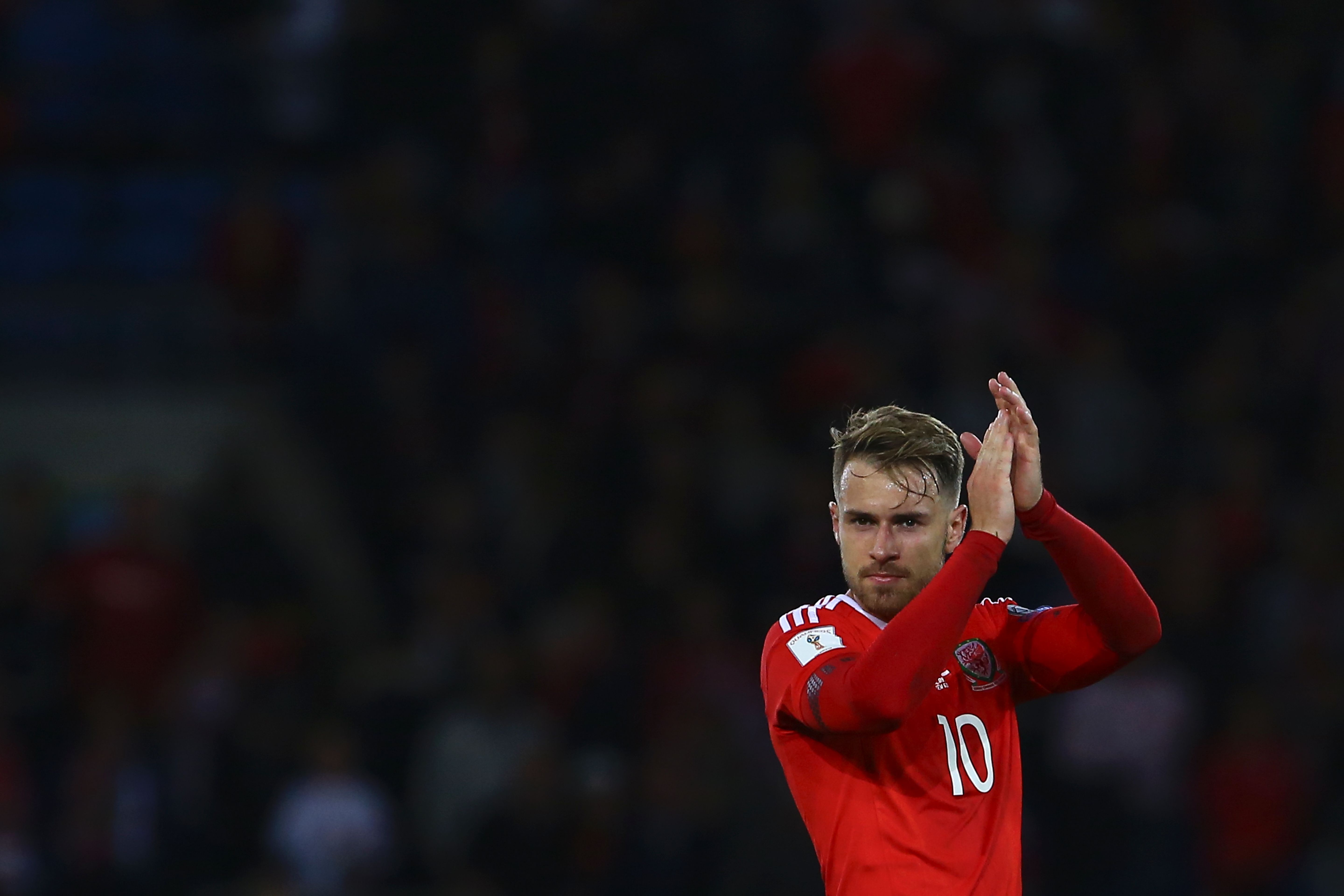 Wales' midfielder Aaron Ramsey applauds the fans at the final whistle of the FIFA World Cup 2018 qualification international football match between Wales and Austria in Cardiff, south Wales, on September 2, 2017. / AFP PHOTO / Geoff CADDICK        (Photo credit should read GEOFF CADDICK/AFP/Getty Images)
