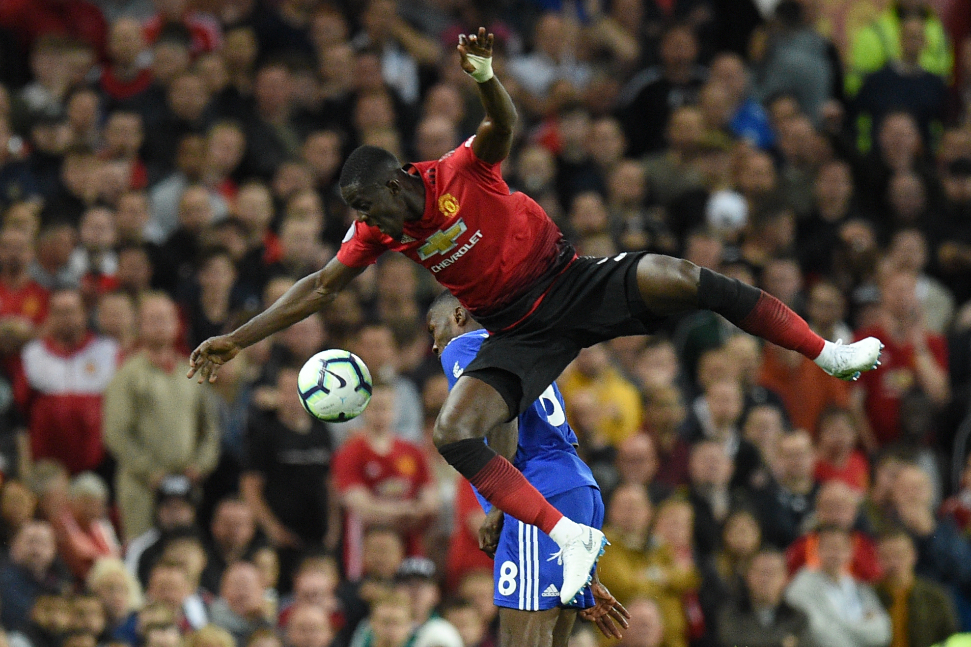 Manchester United's Ivorian defender Eric Bailly (L) vies with Leicester City's Nigerian striker Kelechi Iheanacho during the English Premier League football match between Manchester United and Leicester City at Old Trafford in Manchester, north west England, on August 10, 2018. (Photo by Oli SCARFF / AFP) / RESTRICTED TO EDITORIAL USE. No use with unauthorized audio, video, data, fixture lists, club/league logos or 'live' services. Online in-match use limited to 120 images. An additional 40 images may be used in extra time. No video emulation. Social media in-match use limited to 120 images. An additional 40 images may be used in extra time. No use in betting publications, games or single club/league/player publications /         (Photo credit should read OLI SCARFF/AFP/Getty Images)