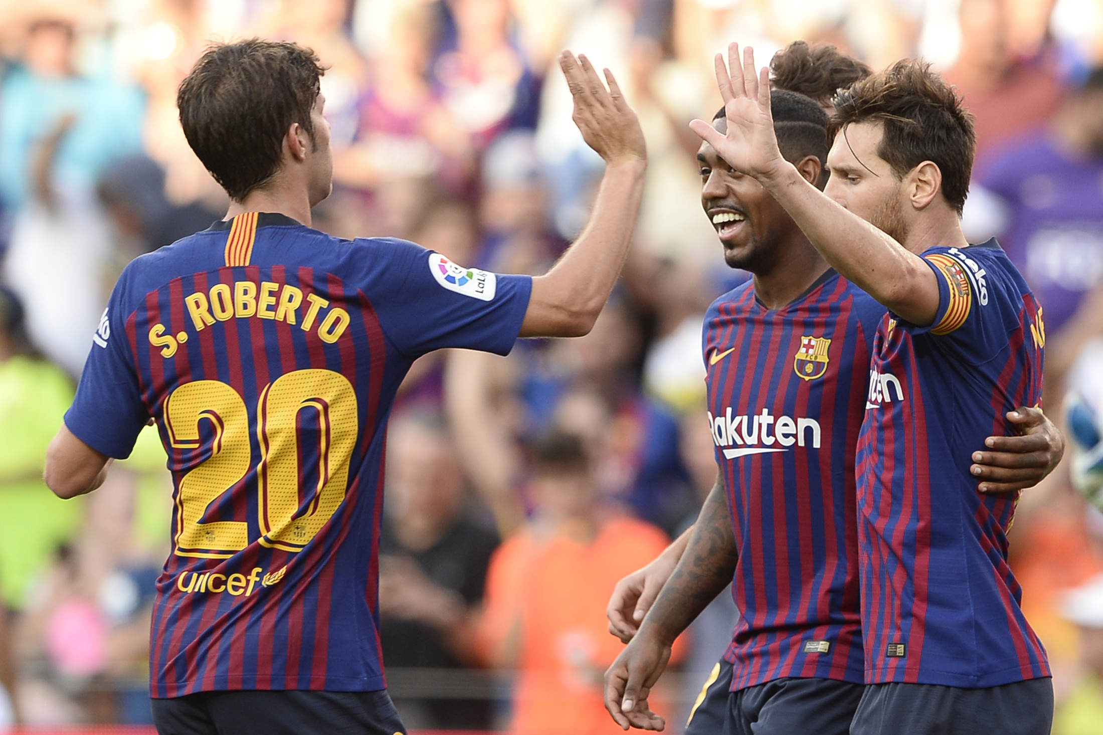 Barcelona's Argentinian forward Lionel Messi (R) celebrates with Barcelona's Spanish midfielder Sergi Roberto (L) and Barcelona's Brazilian midfielder Malcom (C) after scoring a goal during the 53rd Joan Gamper Trophy friendly football match between Barcelona and Boca Juniors at the Camp Nou stadium in Barcelona on August 15, 2018. (Photo by Josep LAGO / AFP)        (Photo credit should read JOSEP LAGO/AFP/Getty Images)