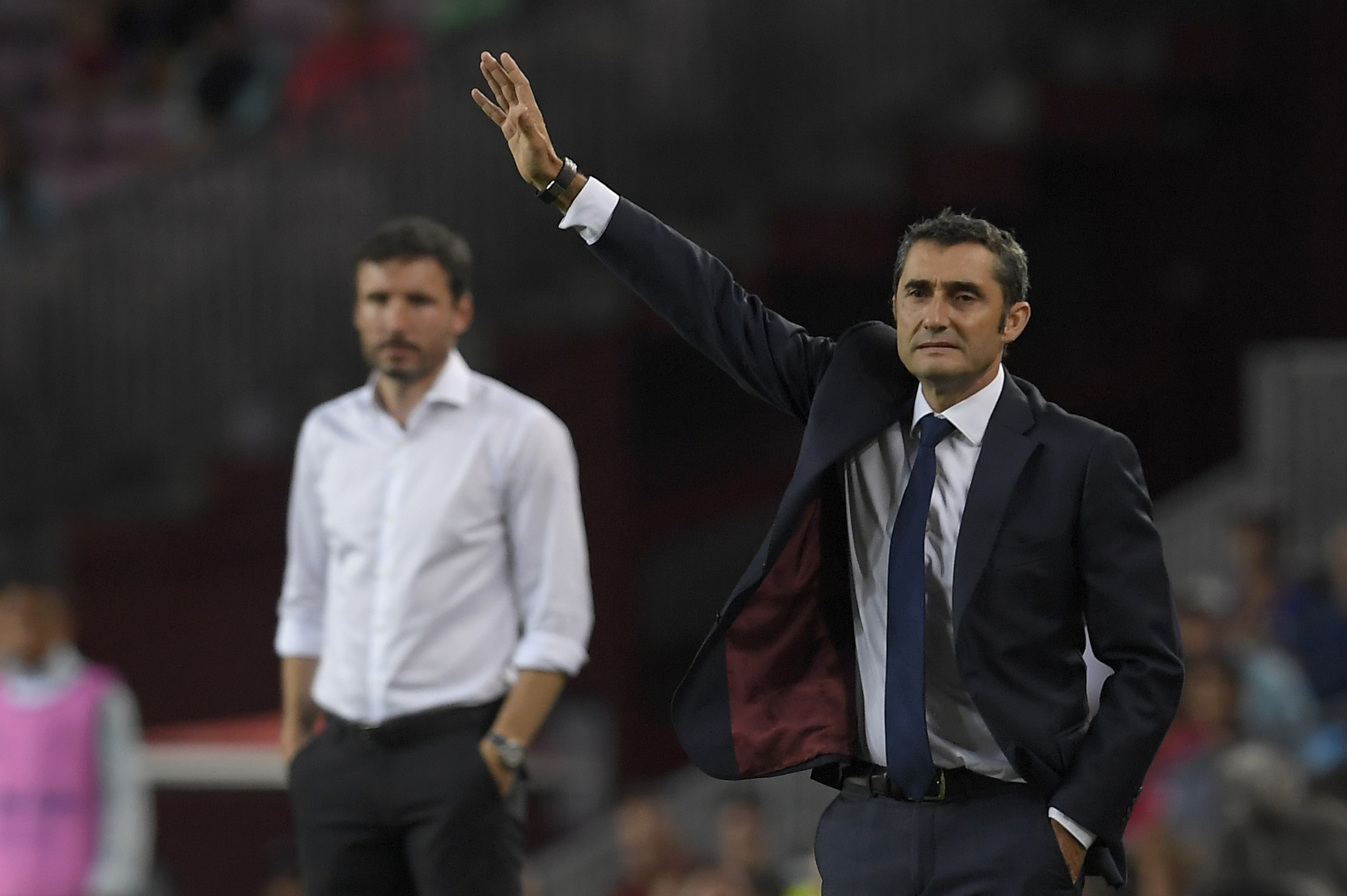 Barcelona's Spanish coach Ernesto Valverde (R) gestures next to PSV Eindhoven's Dutch coach Mark van Bommel (L) during the UEFA Champions' League group B football match FC Barcelona against PSV Eindhoven at the Camp Nou stadium in Barcelona on September 18, 2018. (Photo by LLUIS GENE / AFP)        (Photo credit should read LLUIS GENE/AFP/Getty Images)