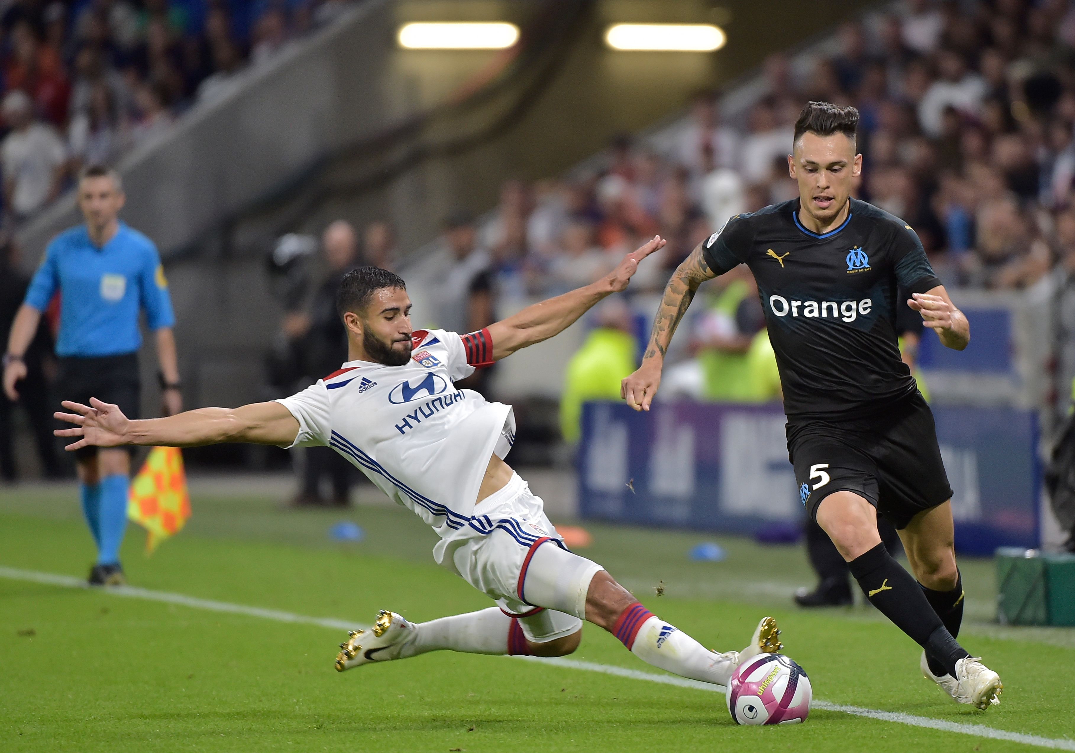 Marseille's Argentinian forward Lucas Ocampos (R) is tackled by Lyon's French forward Nabil Fekir (L) during the French L1 football match between Lyon (OL) and Marseille (OM) on September 23, 2018 at the Groupama stadium in Décines-Charpieu near Lyon. (Photo by ROMAIN LAFABREGUE / AFP)        (Photo credit should read ROMAIN LAFABREGUE/AFP/Getty Images)