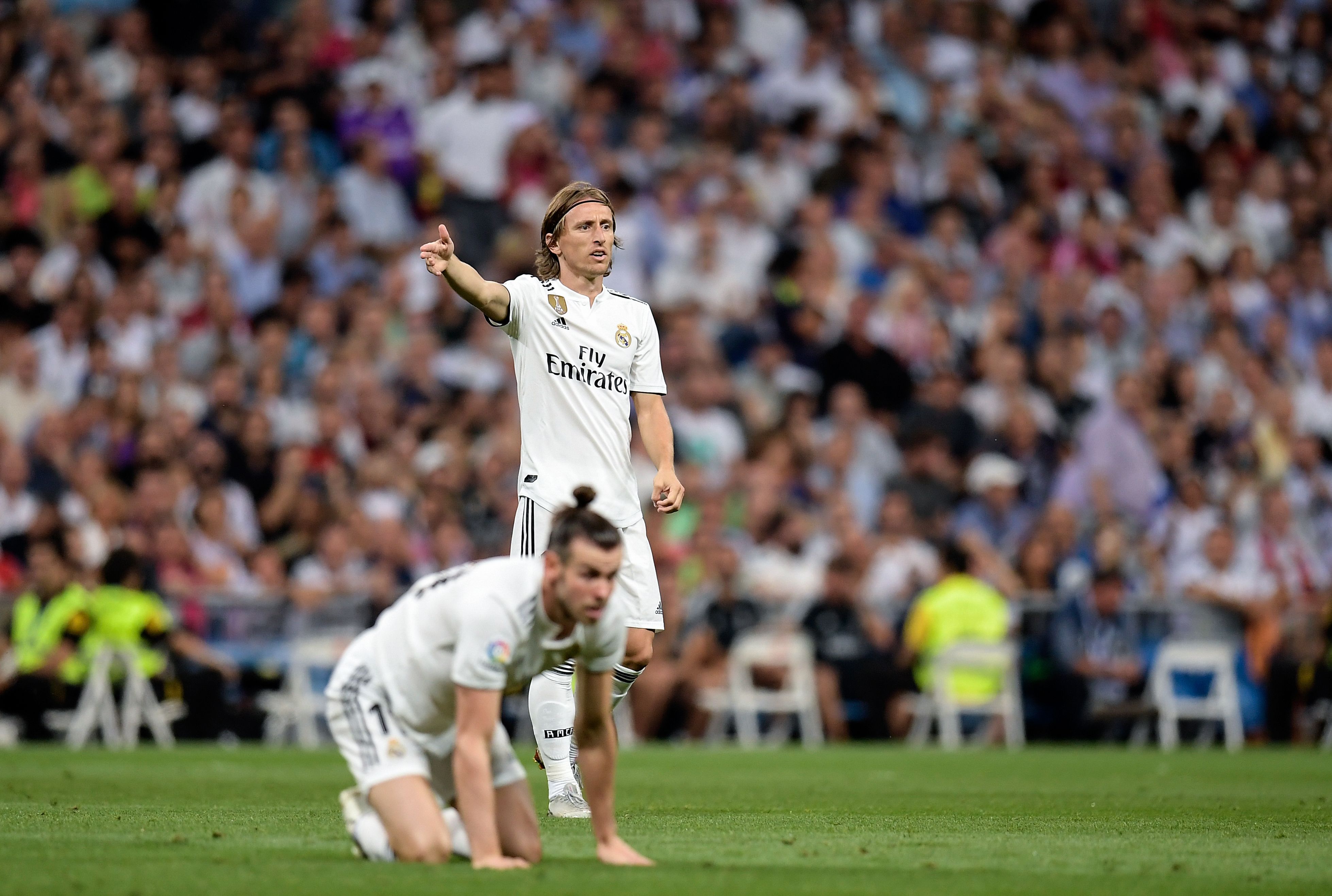 Real Madrid's Croatian midfielder Luka Modric (R) gestures next to Real Madrid's Welsh forward Gareth Bale during the Spanish league football match between Real Madrid CF and Club Atletico de Madrid at the Santiago Bernabeu stadium in Madrid on September 29, 2018. (Photo by OSCAR DEL POZO / AFP)        (Photo credit should read OSCAR DEL POZO/AFP/Getty Images)