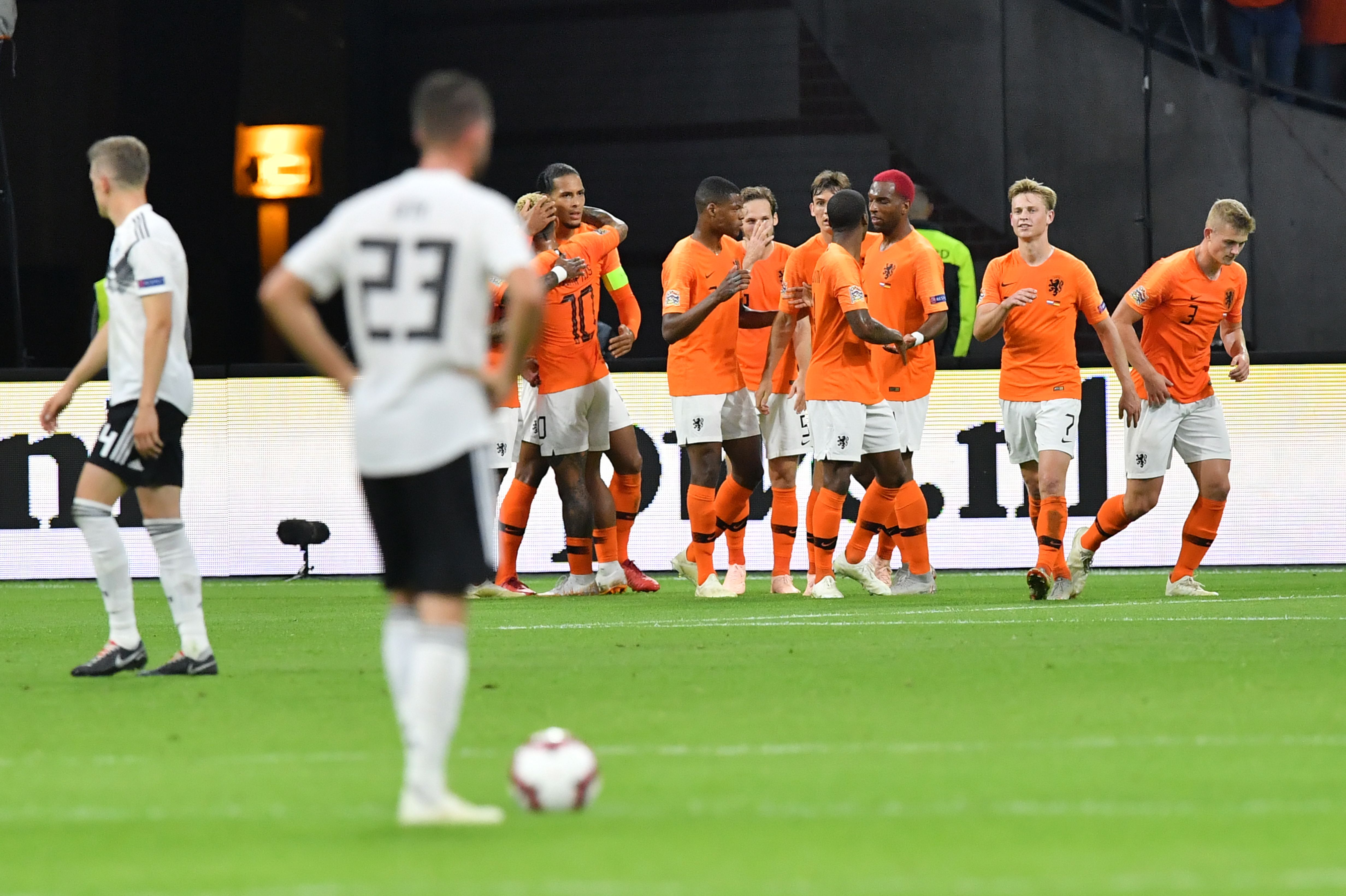 Netherlands' defender Virgil van Dijk (4thL) celebrates with teammates after scoring the opening goal during the UEFA Nations League football match between Netherlands and Germany, on October 13, 2018 at Johan Crujiff ArenA in Amsterdam. (Photo by EMMANUEL DUNAND / AFP)        (Photo credit should read EMMANUEL DUNAND/AFP/Getty Images)