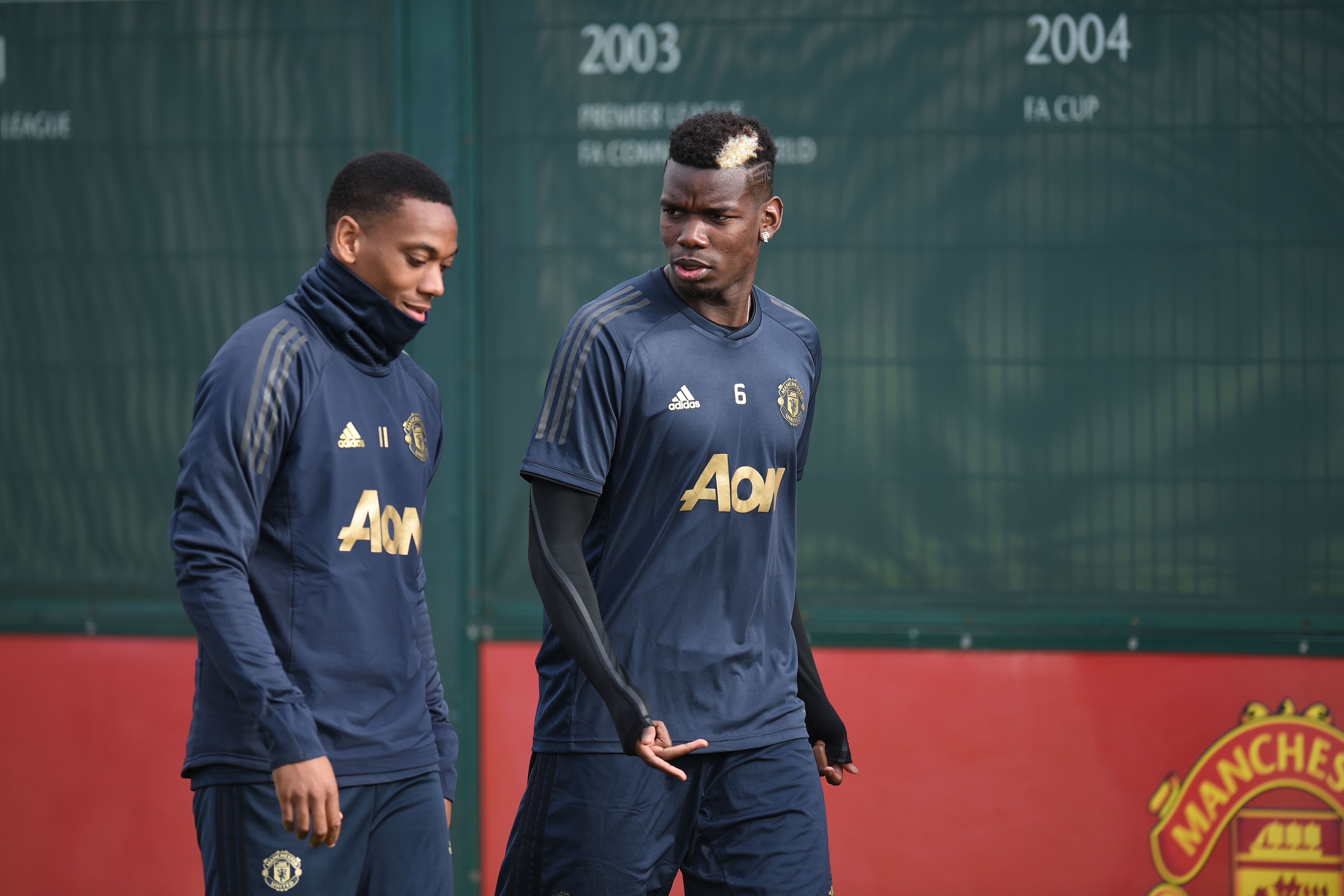 Manchester United's French striker Anthony Martial (L) and Manchester United's French midfielder Paul Pogba (R) arrive for a training session at the Carrington Training complex in Manchester, north west England on October 22, 2018, ahead of their UEFA Champions League group H football match against Juventus on October 23. (Photo by Oli SCARFF / AFP)        (Photo credit should read OLI SCARFF/AFP/Getty Images)