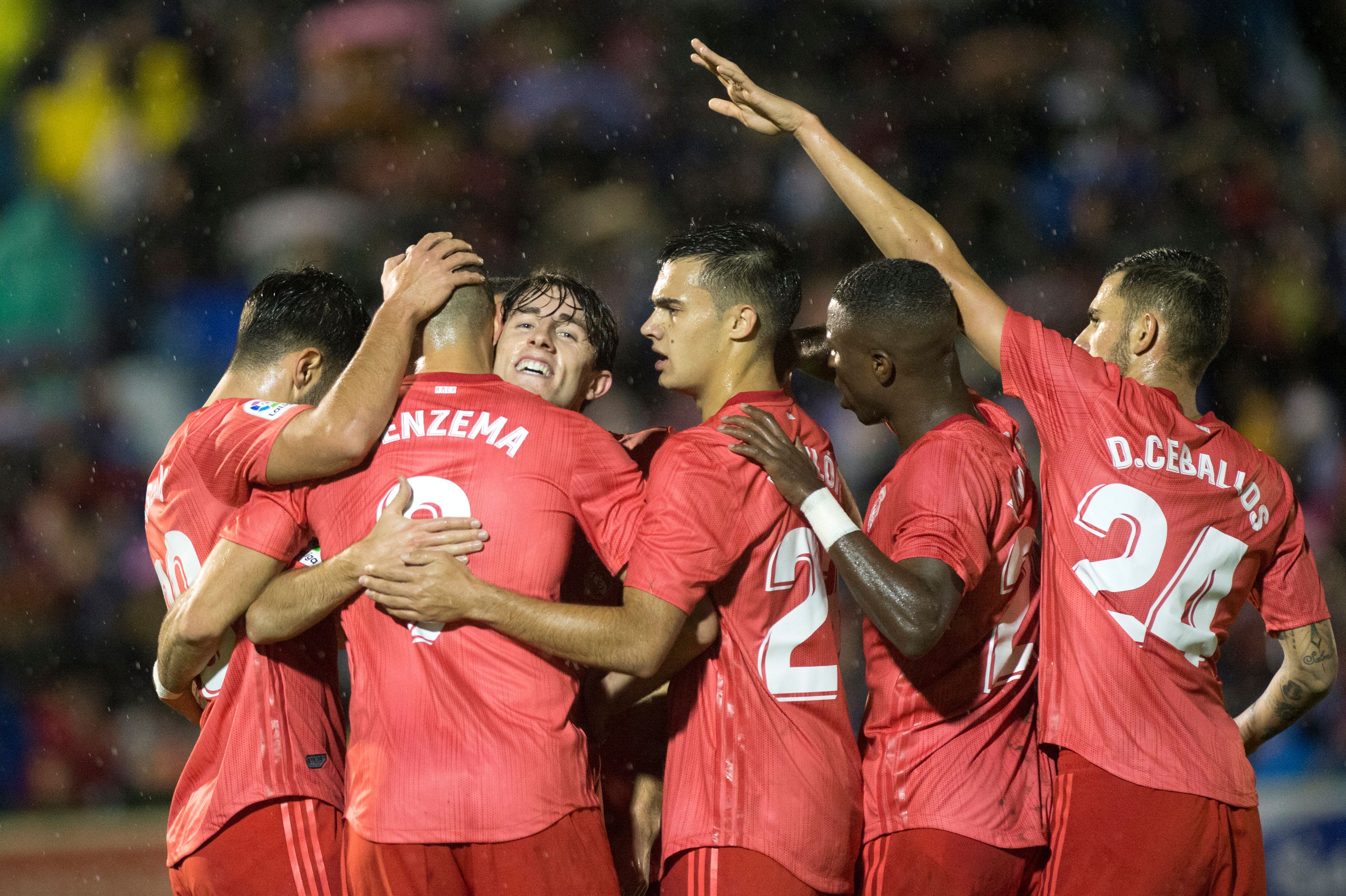 Real Madrid's French forward Karim Benzema (2L) is congratulated by teammates after scoring a goal during the Spanish King's Cup (Copa del Rey) football match between UD Melilla and Real Madrid CF at the Alvarez Claro municipal stadium in the autonomous city of Melilla on October 31, 2018. (Photo by JORGE GUERRERO / AFP)        (Photo credit should read JORGE GUERRERO/AFP/Getty Images)