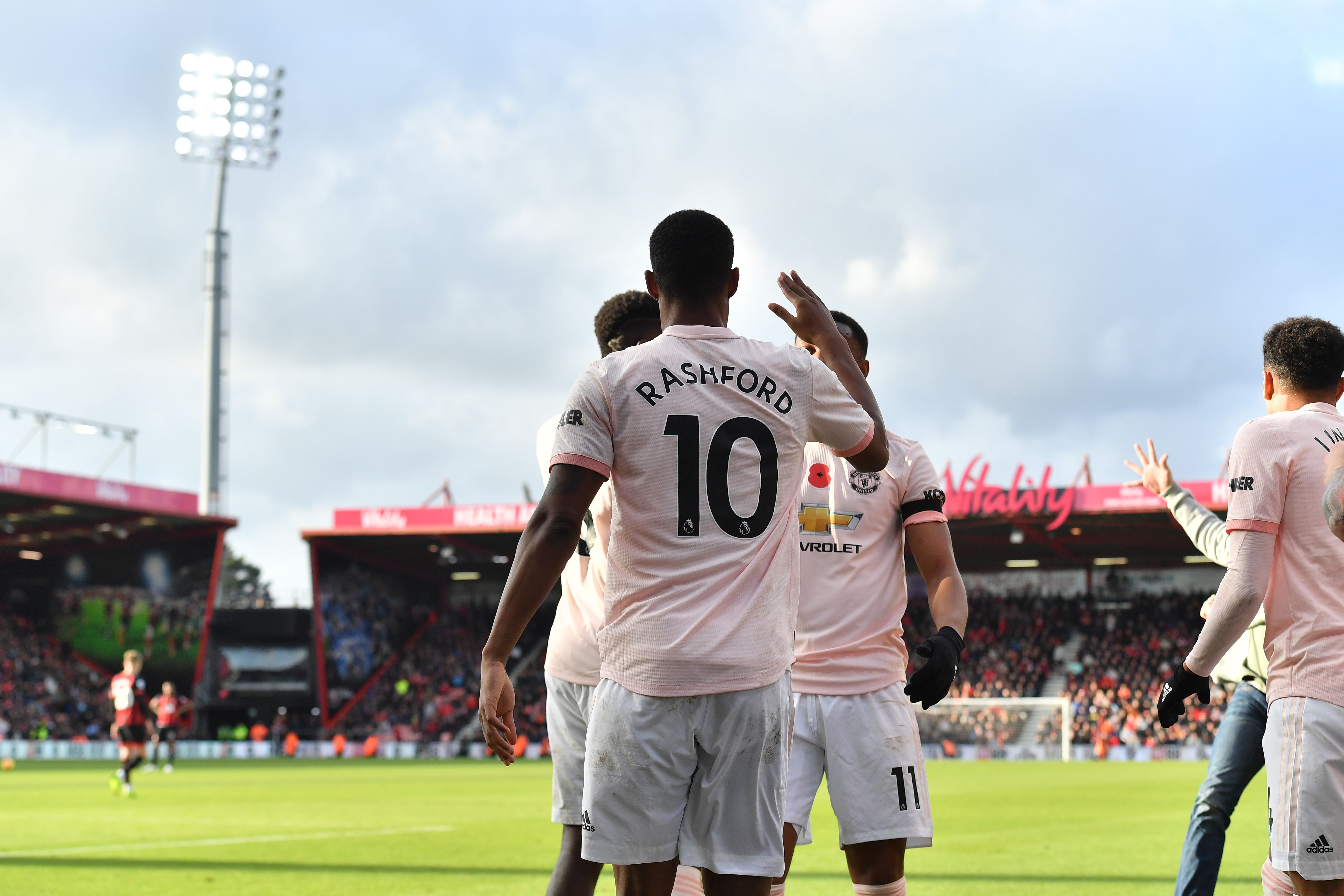 Manchester United's English striker Marcus Rashford (C) celebrates scoring his team's second goal during the English Premier League football match between Bournemouth and Manchester United at the Vitality Stadium in Bournemouth, southern England on November 3, 2018. (Photo by Ben STANSALL / AFP) / RESTRICTED TO EDITORIAL USE. No use with unauthorized audio, video, data, fixture lists, club/league logos or 'live' services. Online in-match use limited to 120 images. An additional 40 images may be used in extra time. No video emulation. Social media in-match use limited to 120 images. An additional 40 images may be used in extra time. No use in betting publications, games or single club/league/player publications. /         (Photo credit should read BEN STANSALL/AFP/Getty Images)