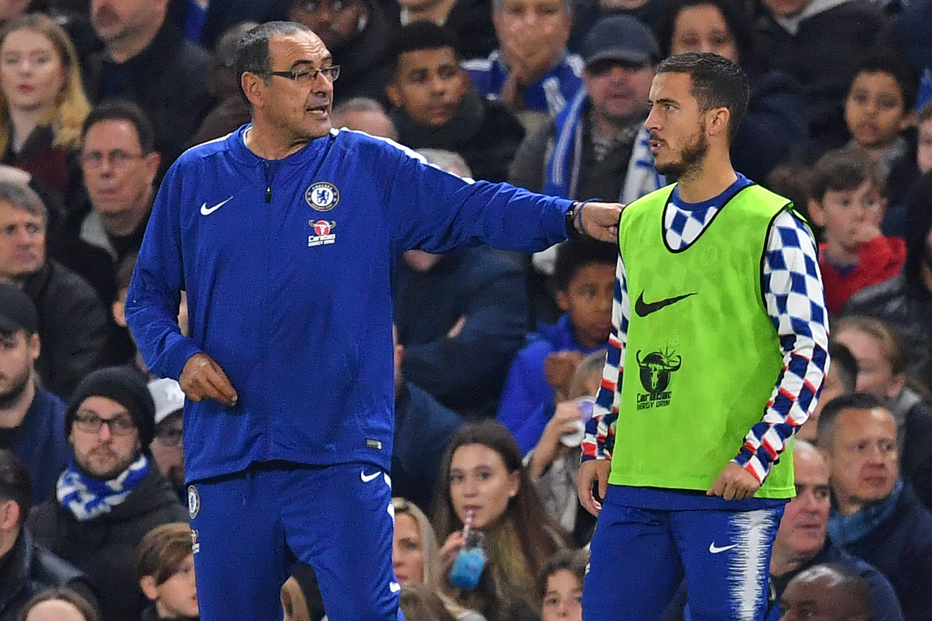 Chelsea's Italian head coach Maurizio Sarri (L) speaks with Chelsea's Belgian midfielder Eden Hazard (R) as he prepares to come on as a substitute during the English Premier League football match between Chelsea and Crystal Palace at Stamford Bridge in London on November 4, 2018. (Photo by Ben STANSALL / AFP) / RESTRICTED TO EDITORIAL USE. No use with unauthorized audio, video, data, fixture lists, club/league logos or 'live' services. Online in-match use limited to 120 images. An additional 40 images may be used in extra time. No video emulation. Social media in-match use limited to 120 images. An additional 40 images may be used in extra time. No use in betting publications, games or single club/league/player publications. /         (Photo credit should read BEN STANSALL/AFP/Getty Images)