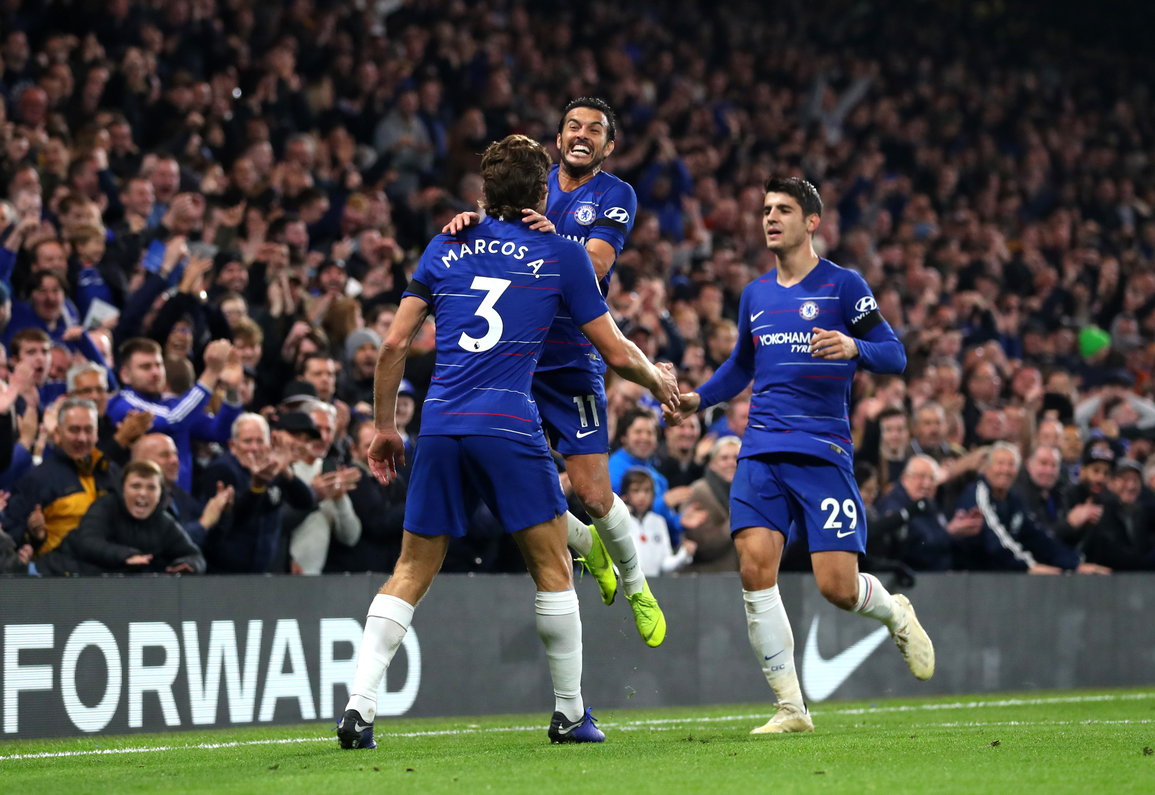 LONDON, ENGLAND - NOVEMBER 04:  Pedro of Chelsea celebrates with teammates Marcos Alonso and Alvaro Morata after scoring his team's third goal during the Premier League match between Chelsea FC and Crystal Palace at Stamford Bridge on November 4, 2018 in London, United Kingdom.  (Photo by Catherine Ivill/Getty Images)