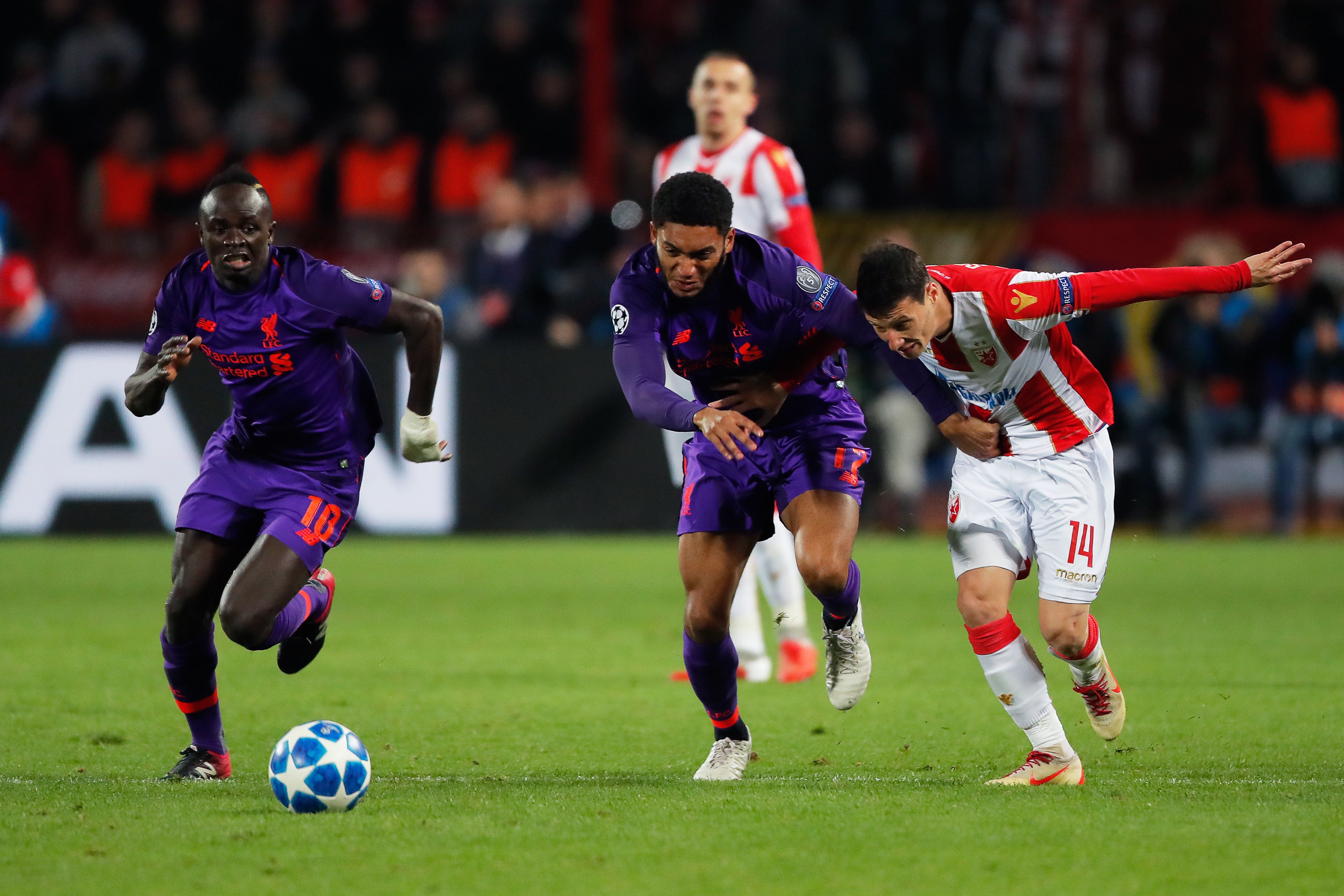 Red Star Belgrade's Serbian forward Slavoljub Srnic (R) vies for the ball with Liverpool's Senegalese midfielder Sadio Mane (L) and Liverpool's English defender Joe Gomez (C)  during the UEFA Champions League Group C second-leg football match between Red Star Belgrade and Liverpool FC at the Rajko Mitic Stadium in Belgrade on November 6, 2018. (Photo by Pedja Milosavljevic / AFP)        (Photo credit should read PEDJA MILOSAVLJEVIC/AFP/Getty Images)